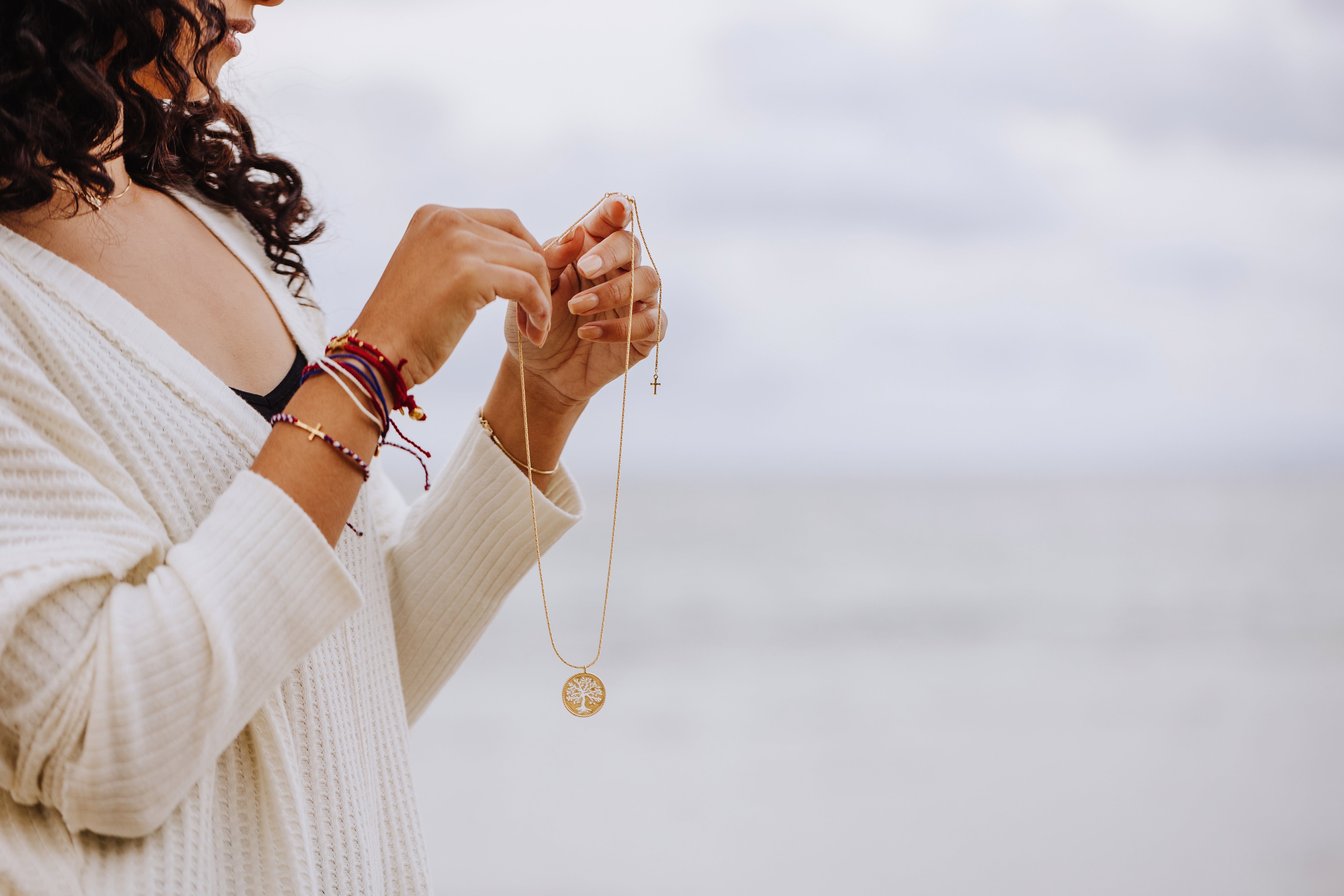 RizenJewelry model wearing cross bracelet. 