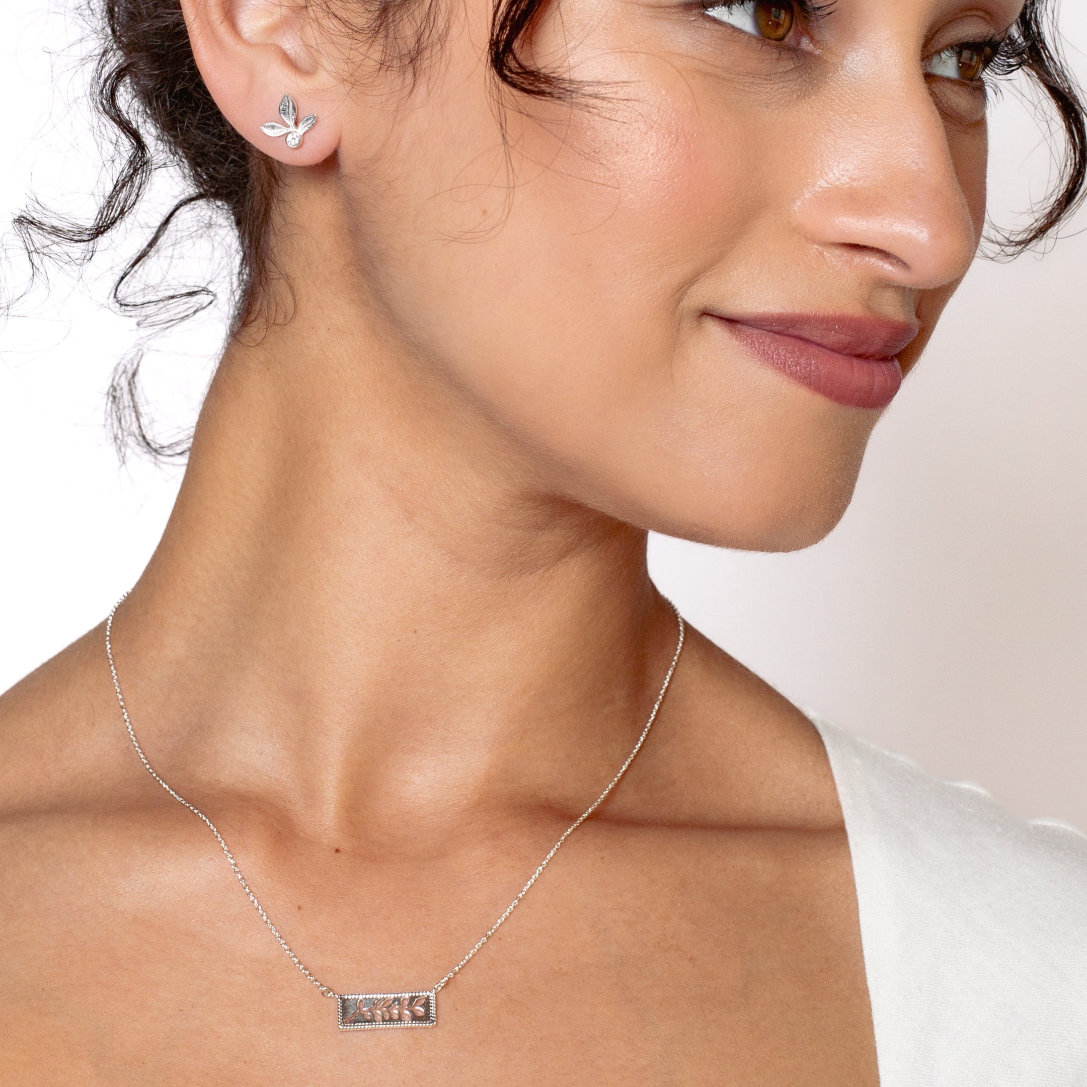Serene Reverence Jewelry Set in sterling silver features the exquisite Olive Leaf Earrings and beautiful Branch Necklace rom the Rooted Collection worn by Rizen Jewelry christian female jewelry model.