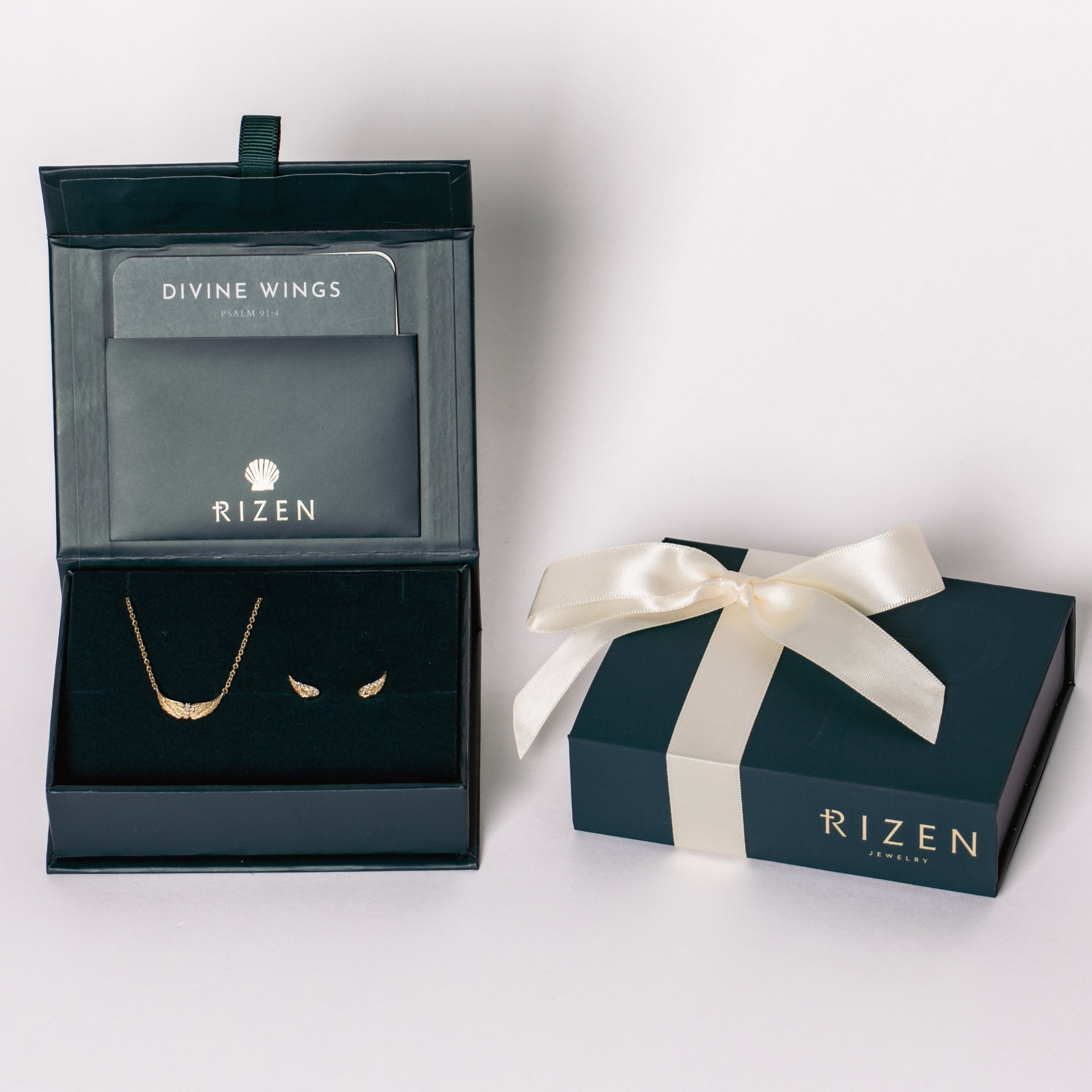 18k gold plated Divine Refuge jewelry gift set in the Rizen Jewelry Gift Box featuring the Divine Wings mini necklace and matching wing earrings. Necklace features a Cross at the center of the wings.