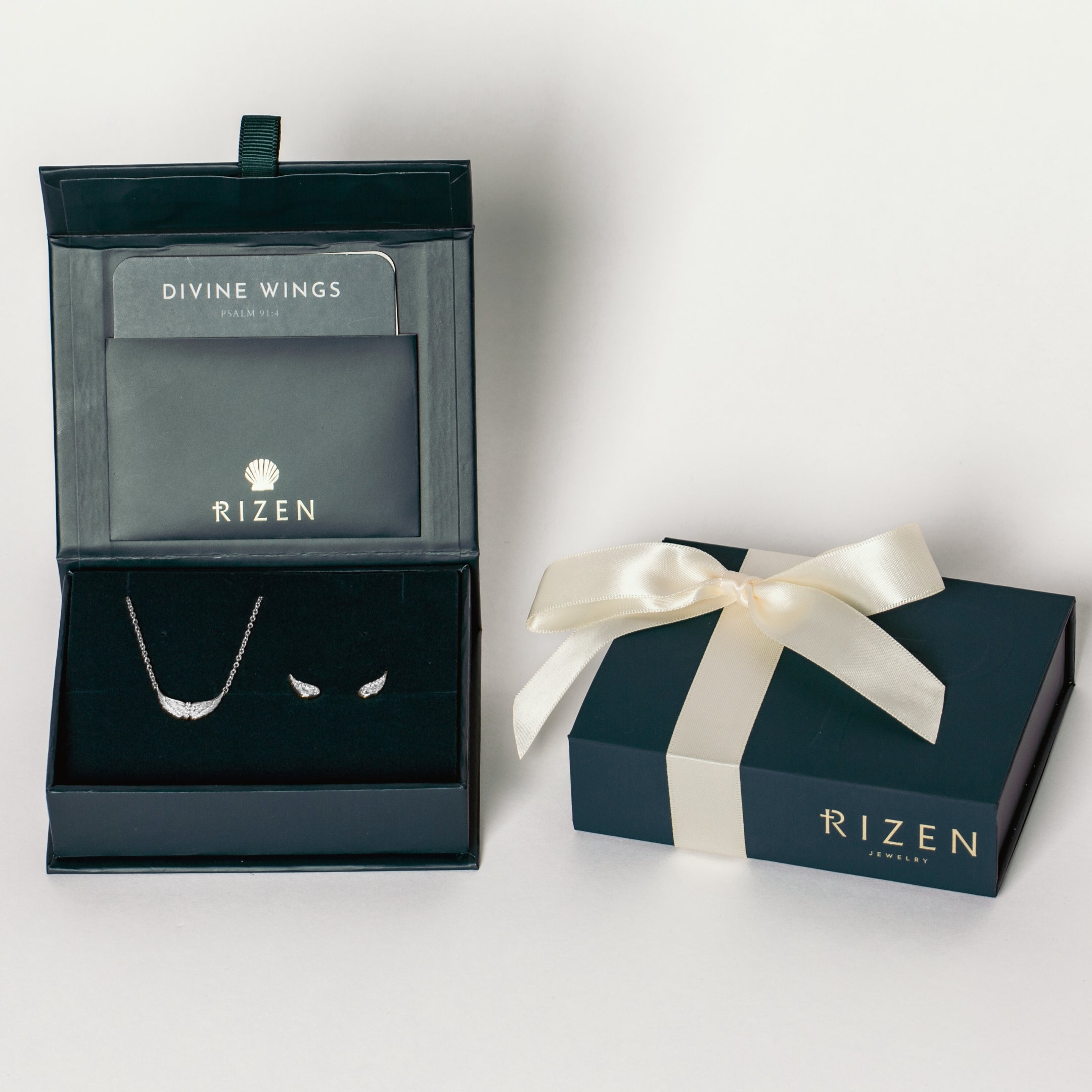 Sterling silver Divine Refuge Rizen Jewelry Gift Box Set featuring the Divine Wings mini necklace with dainty cross and matching earrings.