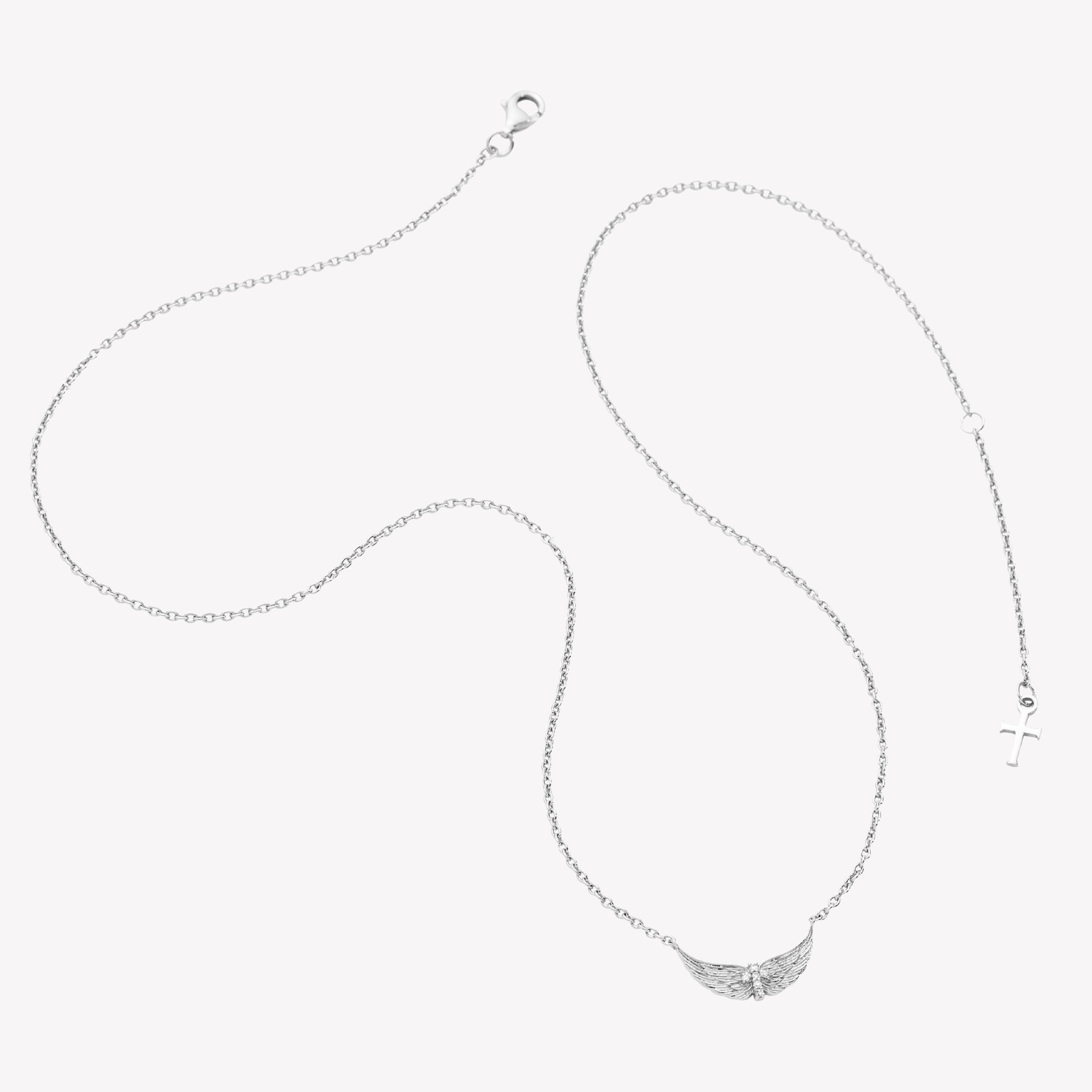 Sterling silver necklace featuring uplifted angel wings with a radiant cubic zirconia cross at the center and textured feather detail. Set on an adjustable 19.5 in cable chain with a dainty cross tag by Rizen Jewelry.