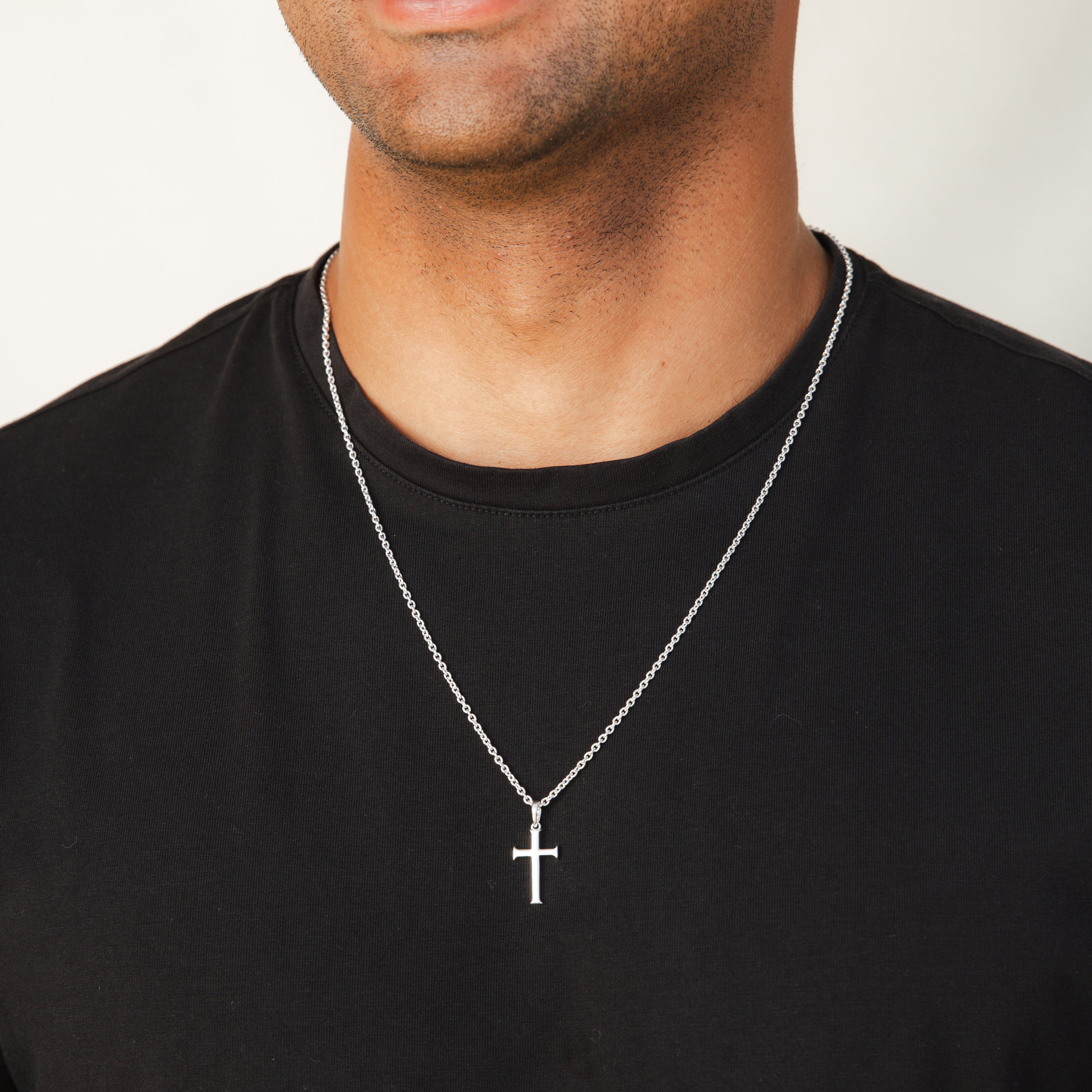 Male Christian Model wearing Rizen Jewelry Large Cross Pendant unisex necklace in sterling silver hanging from a long fully adjustable cable chain.