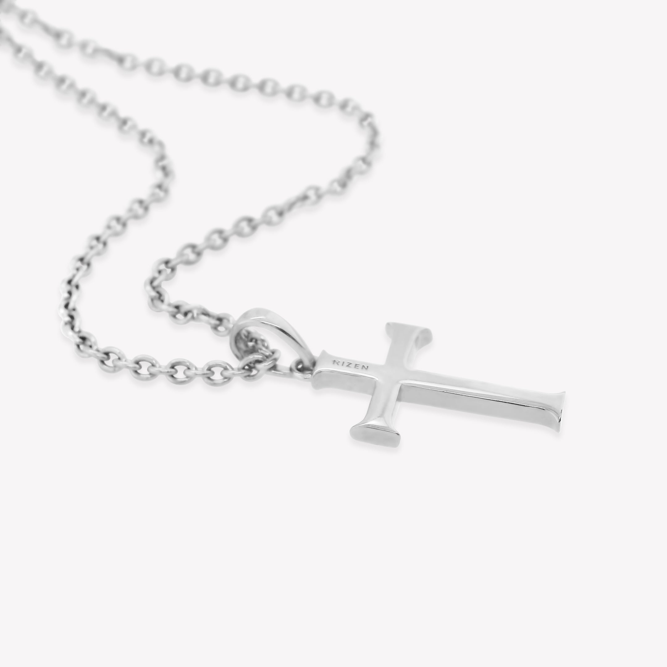 Backside of Rizen Jewelry Large Cross Pendant unisex necklace in sterling silver. The pendant is enraved RIZEN along top half of cross and  hangs from a long fully adjustable cable chain.