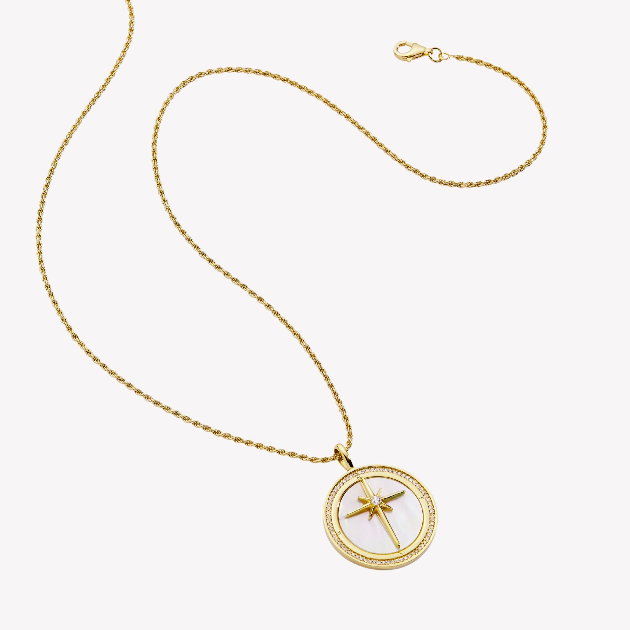 18k gold plated compass medallion necklace with mother-of-pearl inlay and John 14:6 scripture etched on the back. Pendant set on a 21in adjustable rope chain. There is a channel set cubic zirconia boarder around the compass pendant.