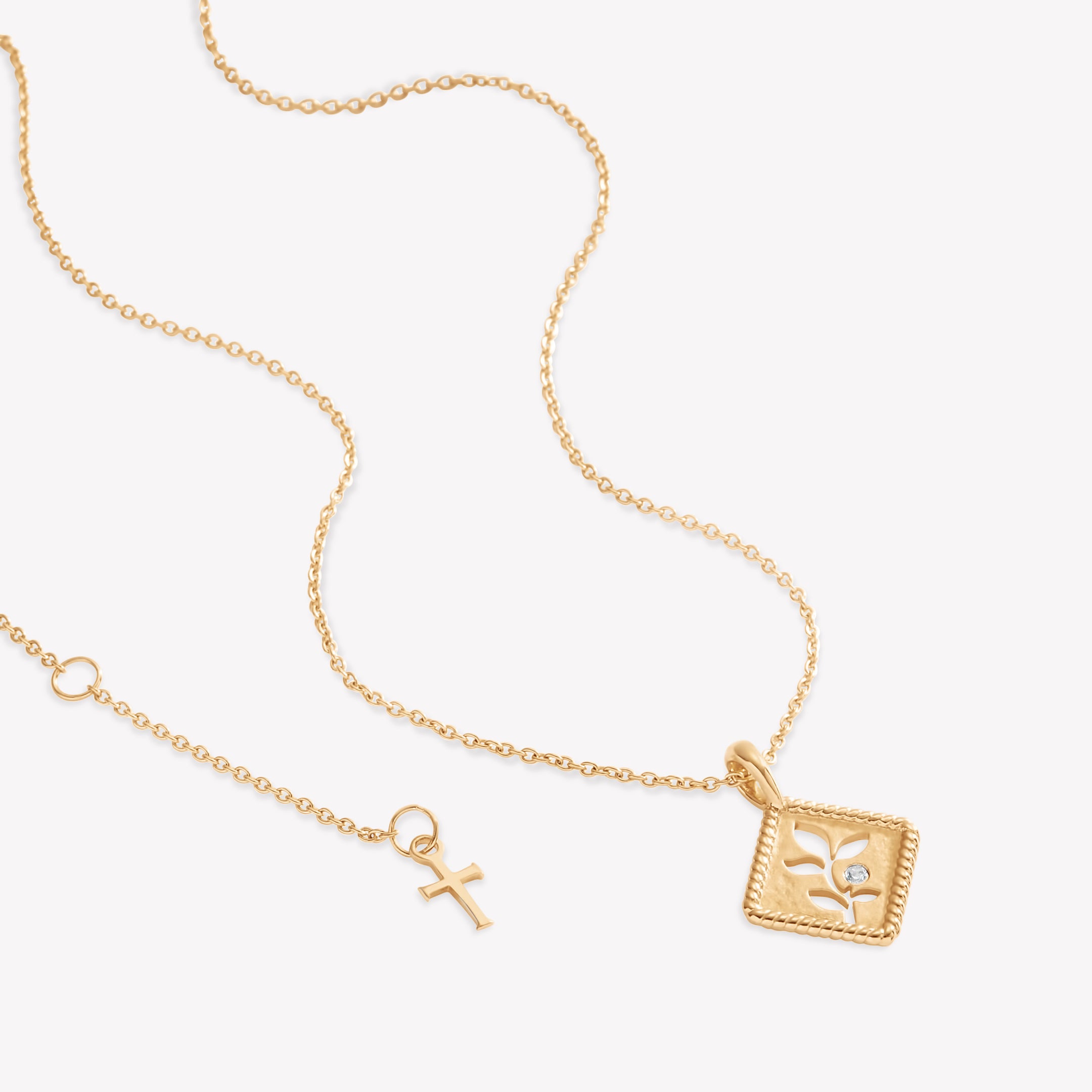 18k gold vermeil Olive Leaf Necklace with a subtle matte finish, intricate rope border in a diamond shape, and a flush set delicate cubic zirconiaset on a classic cable chain by Rizen Jewelry.