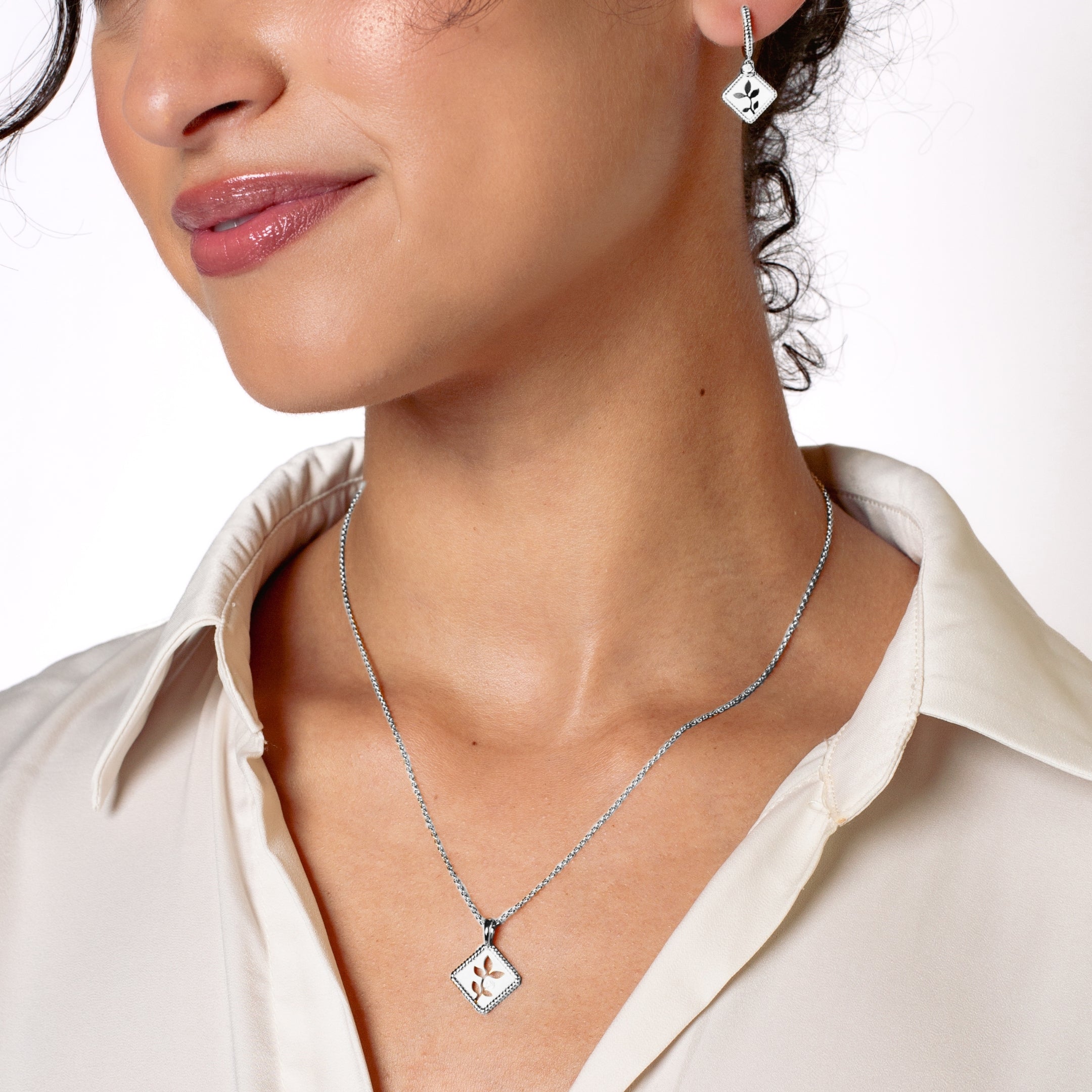 Peaceful Radiance Jewelry Set in sterling silver featuring the exquisite Olive Leaf Necklace and Hoop Earrings rom the Rooted Collection worn by Rizen Jewelry christian female jewelry model. .