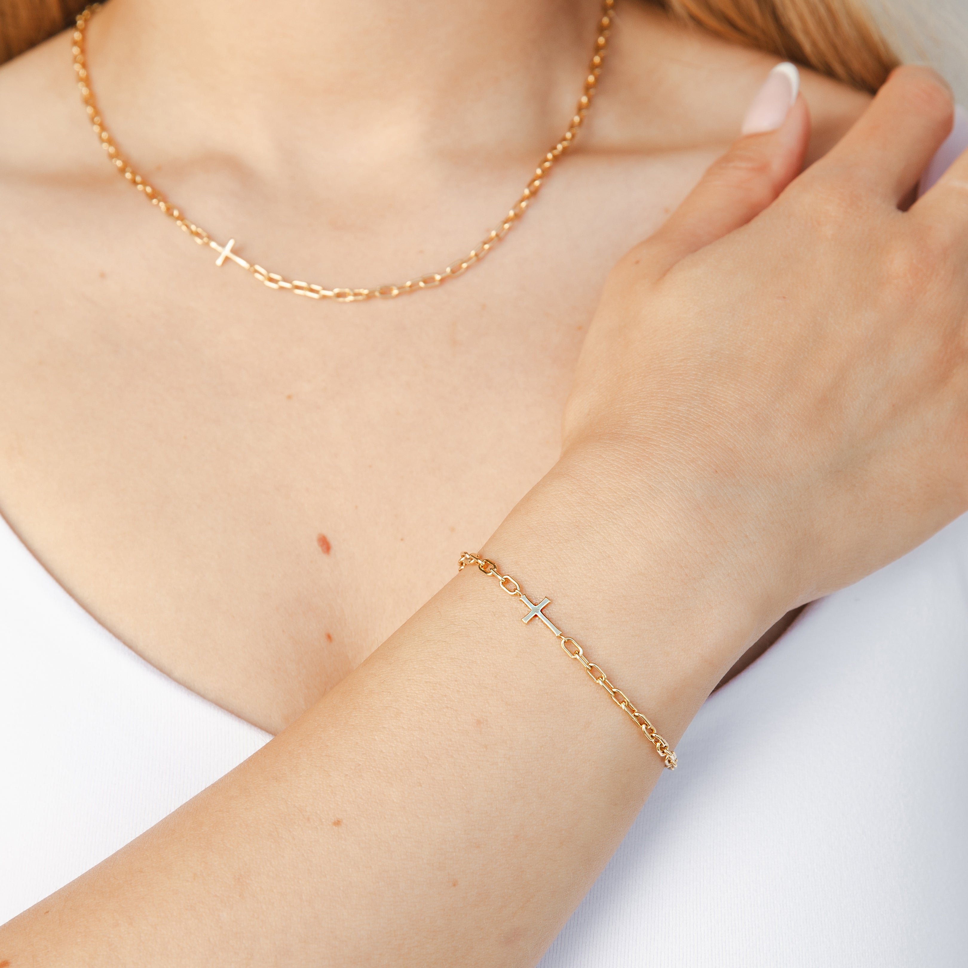 Mini Chain Breaker Cross Bracelet in 18k gold vermeil from the calvary collection by Rizen Jewelry worn by Christian model and paired with matching necklace.