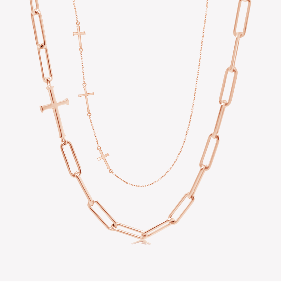 Close up of the chain breaker and calvary cross station necklaces in rose gold vermeil from the calvary collection by Rizen Jewelry