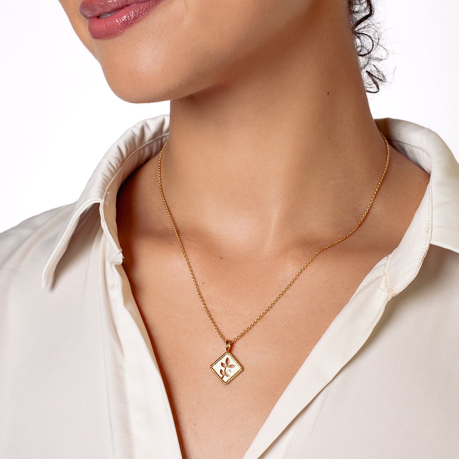 Olive Leaf Pendant Necklace symbolizing peace is expertly crafted  in 18k Gold Vermeil with cubic zirconia from the Rooted Collection worn by the Rizen Jewelry christian female jewelry model.