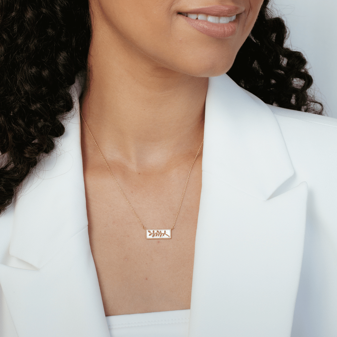 Christian woman wearing 18k gold vermeil Olive Branch necklace from the Rooted Collection by Rizen Jewelry.
