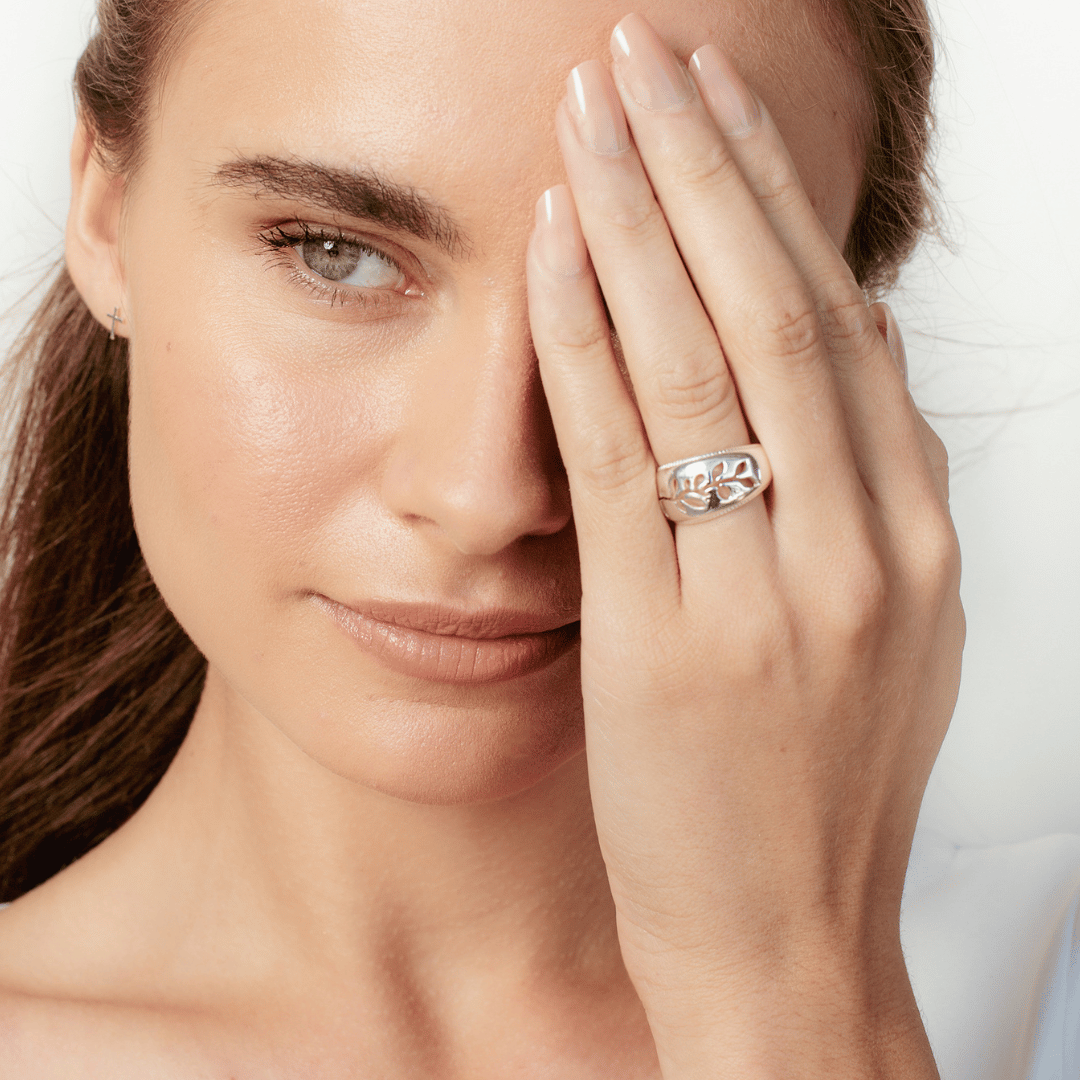 Close up of christian model wearing sterling silver Olive Branch Ring from the Rooted collection by Rizen Jewelry. 