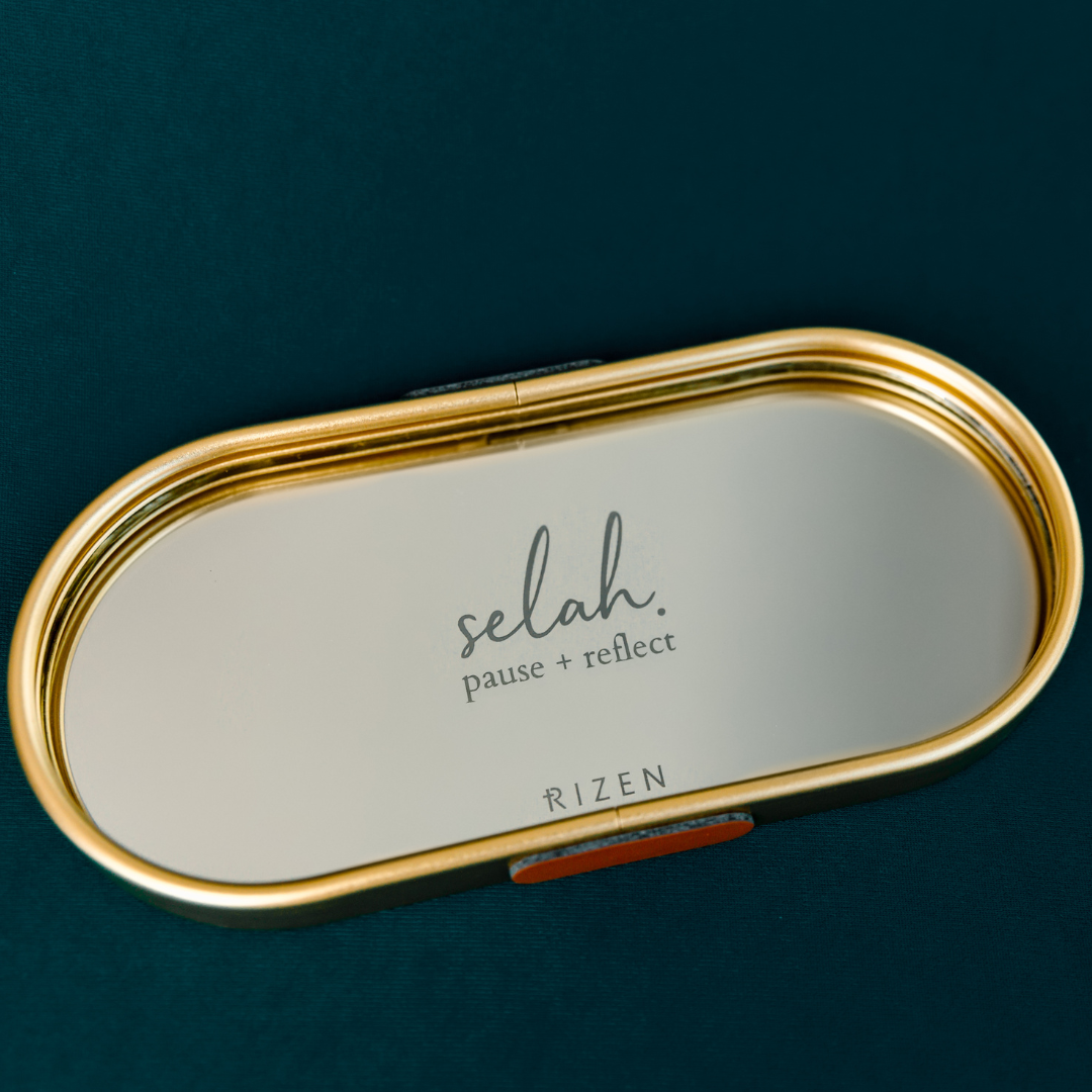 Rizen Jewelry Oval Mirrored Jewelry Dish with Gold Trim that is etched Selah. pause + reflect and the RIZEN logo.