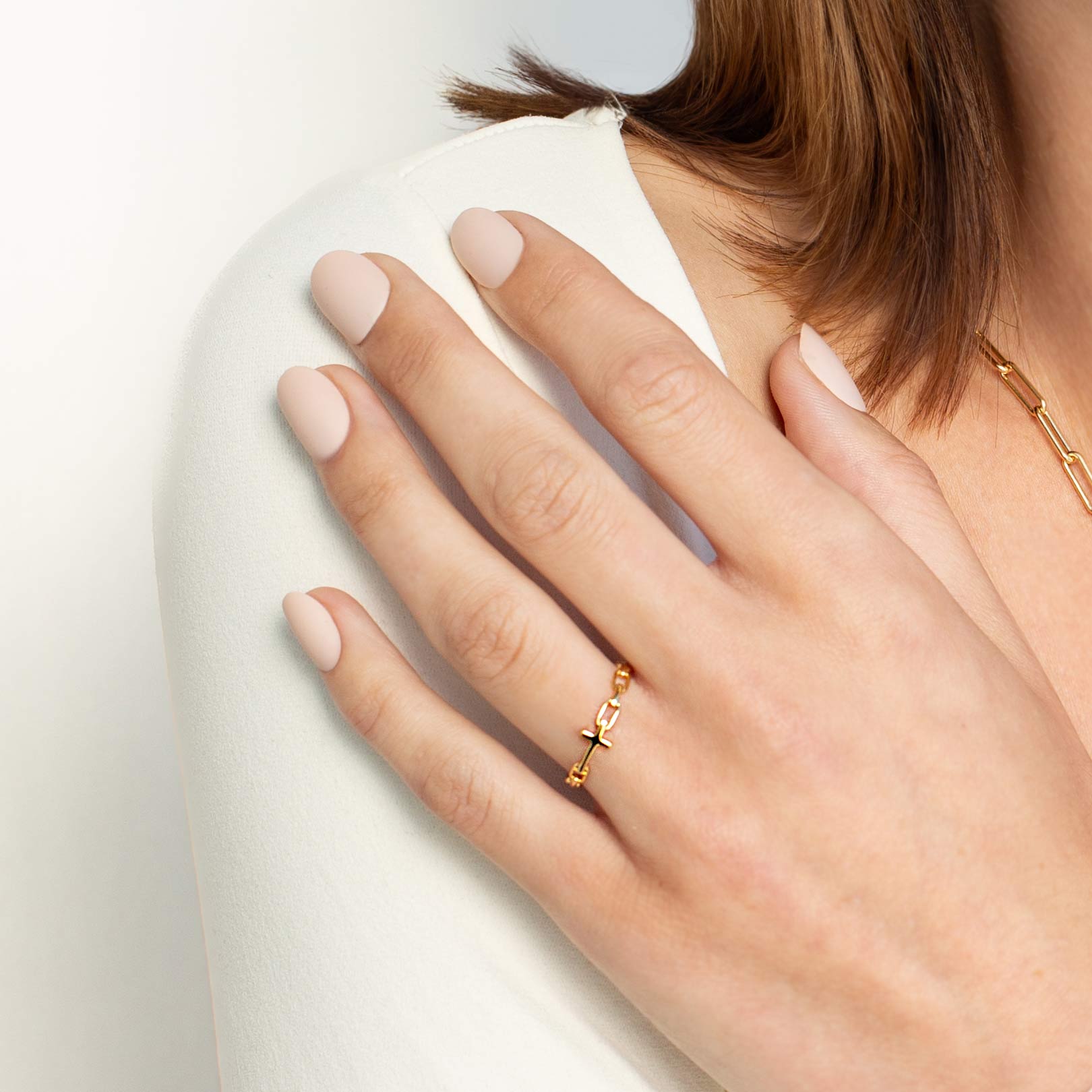 Close up of a christian woman wearing the 18k gold Chain Breaker Cross Ring from the Calvary Collection by Rizen Jewelry.