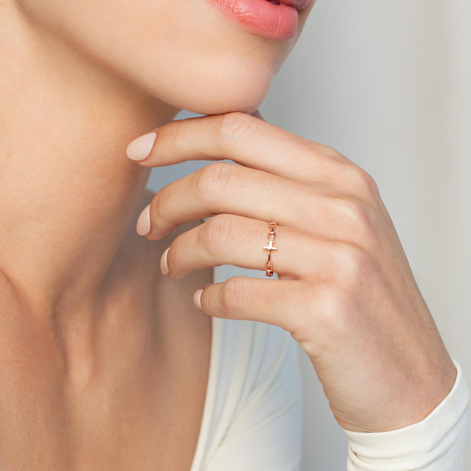 Close up of a christian woman wearing the 18k rose gold Chain Breaker Cross Ring from the Calvary Collection by Rizen Jewelry.