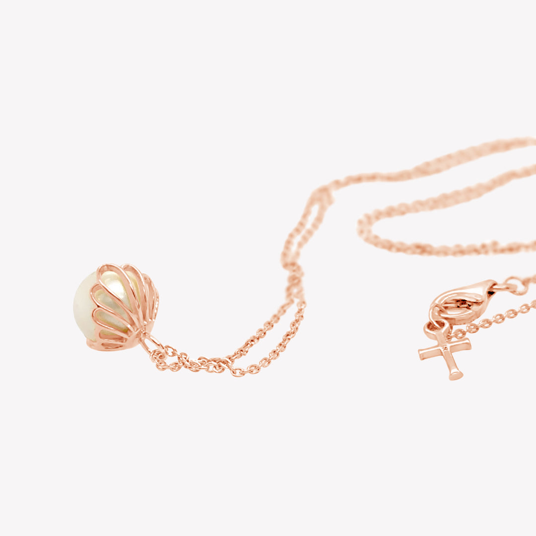Rizen Jewelry shell encased pearl necklace in rose gold vermeil from the Becoming Collection.