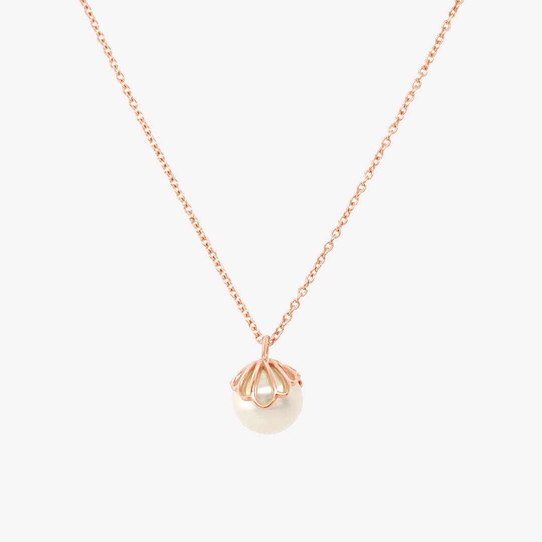 Rizen Jewelry shell encased pearl necklace in rose gold vermeil from the Becoming Collection.