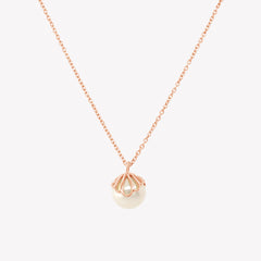Rizen Jewelry shell encased pearl necklace in rose gold vermeil from the Becoming Collection.