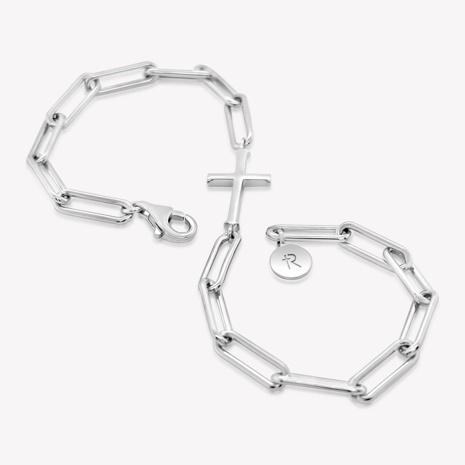 Rizen Jewelry Chain Breaker bracelet in Sterling Silver.  Elegant Cross Pendant breaks up the contemporary paper clip link chain with classic lobster clasp  closure, and circular Rizen tag on last link of chain wrapped in the shape of an infinity symbol.