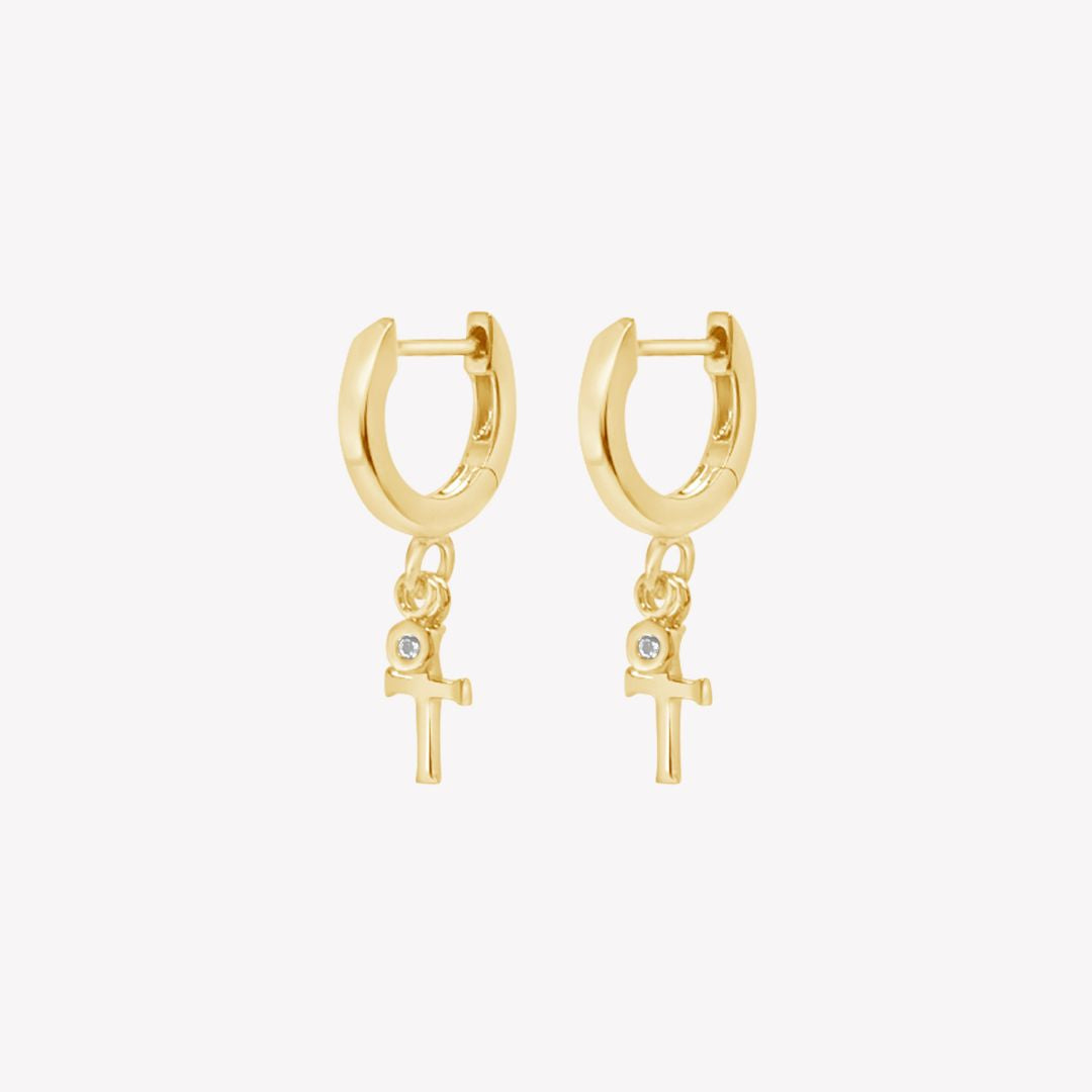 Rizen Jewelry gold vermeil Cross Huggie Hoop Earrings with white topaz stone dangle from the Calvary Collection.