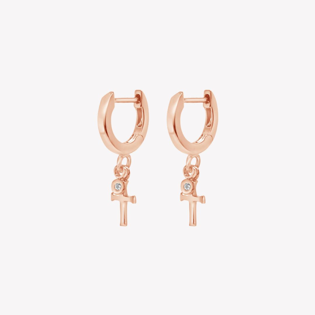 Rizen Jewelry rose gold vermeil Cross Huggie Hoop Earrings with white topaz stone dangle from the Calvary Collection.