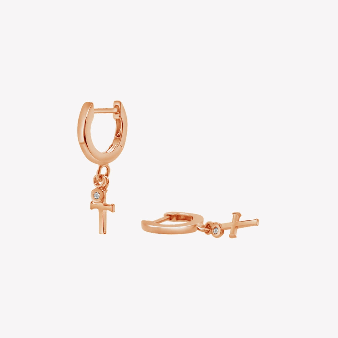 Rizen Jewelry rose gold vermeil Cross Huggie Hoop Earrings with white topaz stone dangle from the Calvary Collection.