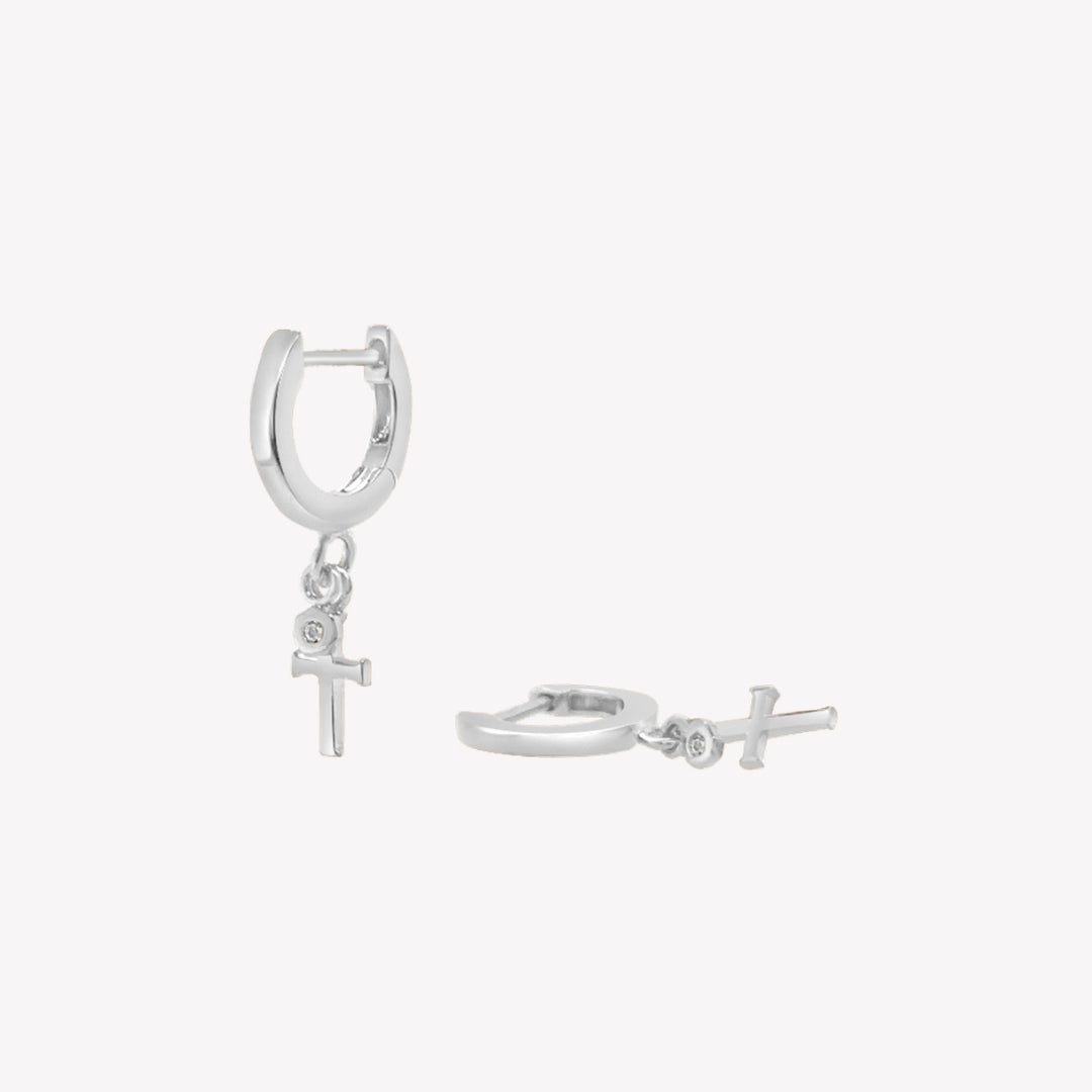 Rizen Jewelry sterling silver Cross Huggie Hoop Earrings with white topaz stone dangle from the Calvary Collection.