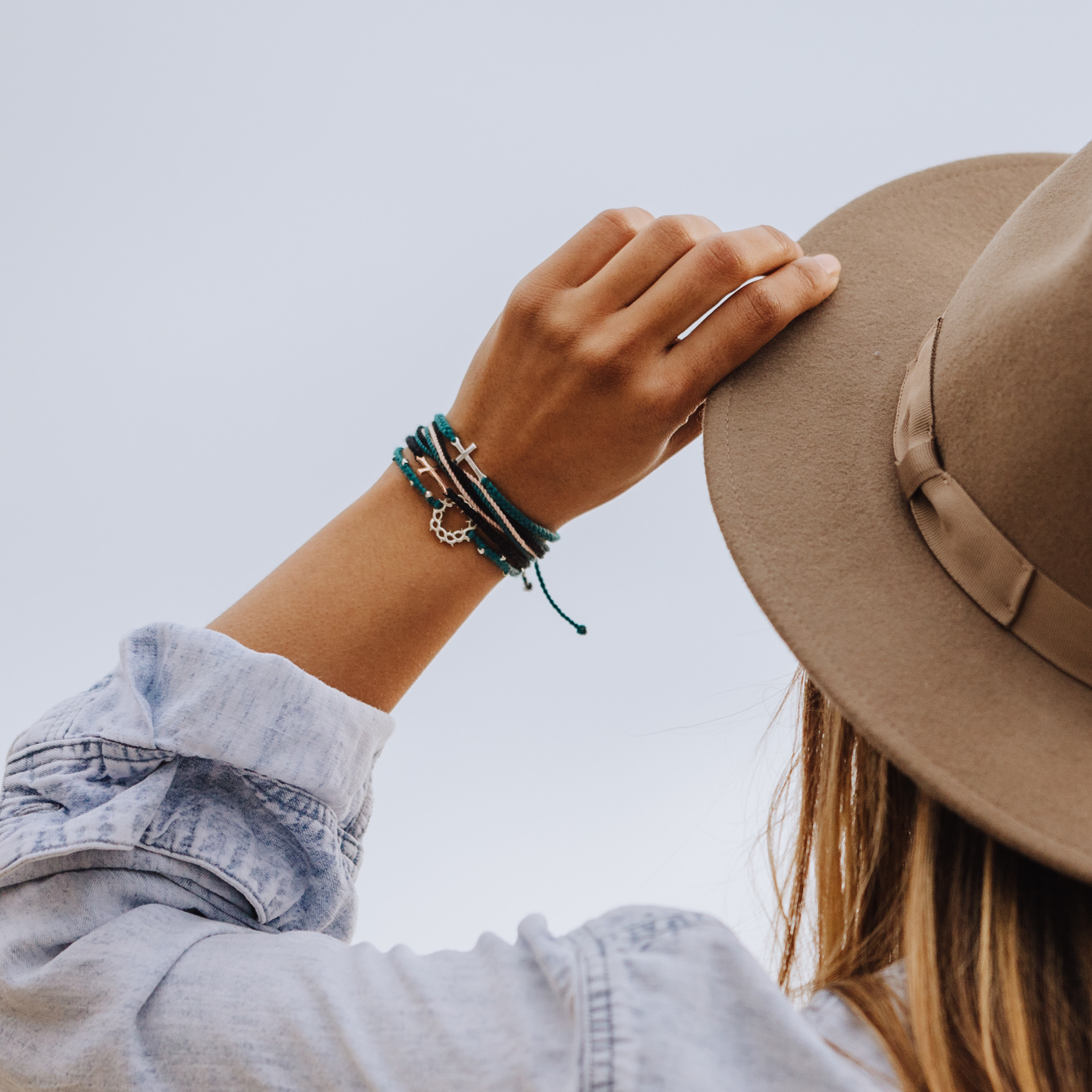 Rizen Jewelry Made4Ministry Azure blue Child of God Cross Bracelet styled with Christian inspired friendship bracelets.