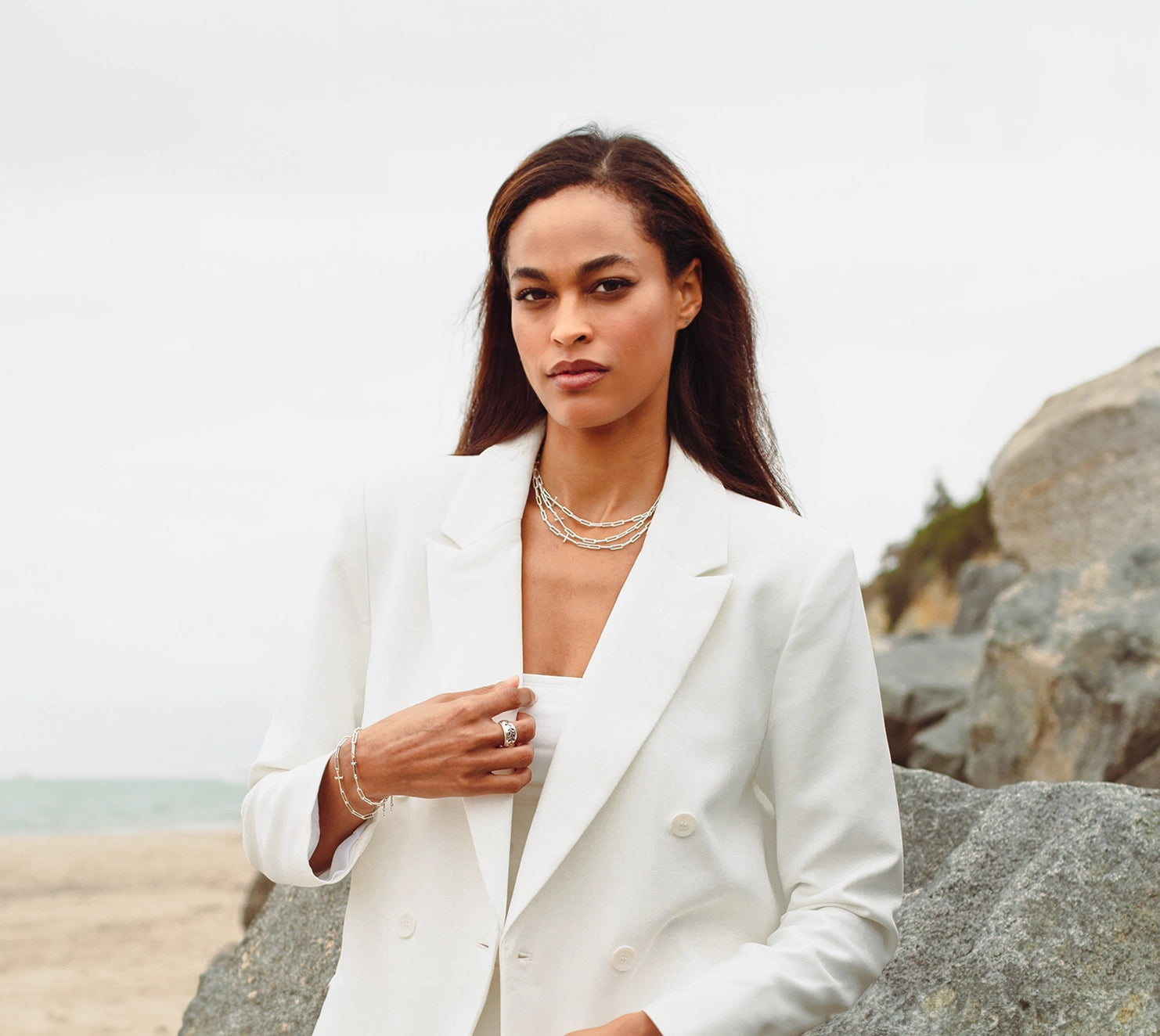 Christian professional woman wearing the silver Chain Breaker necklaces and bracelets from the Calvary Collection by Rizen Jewelry.