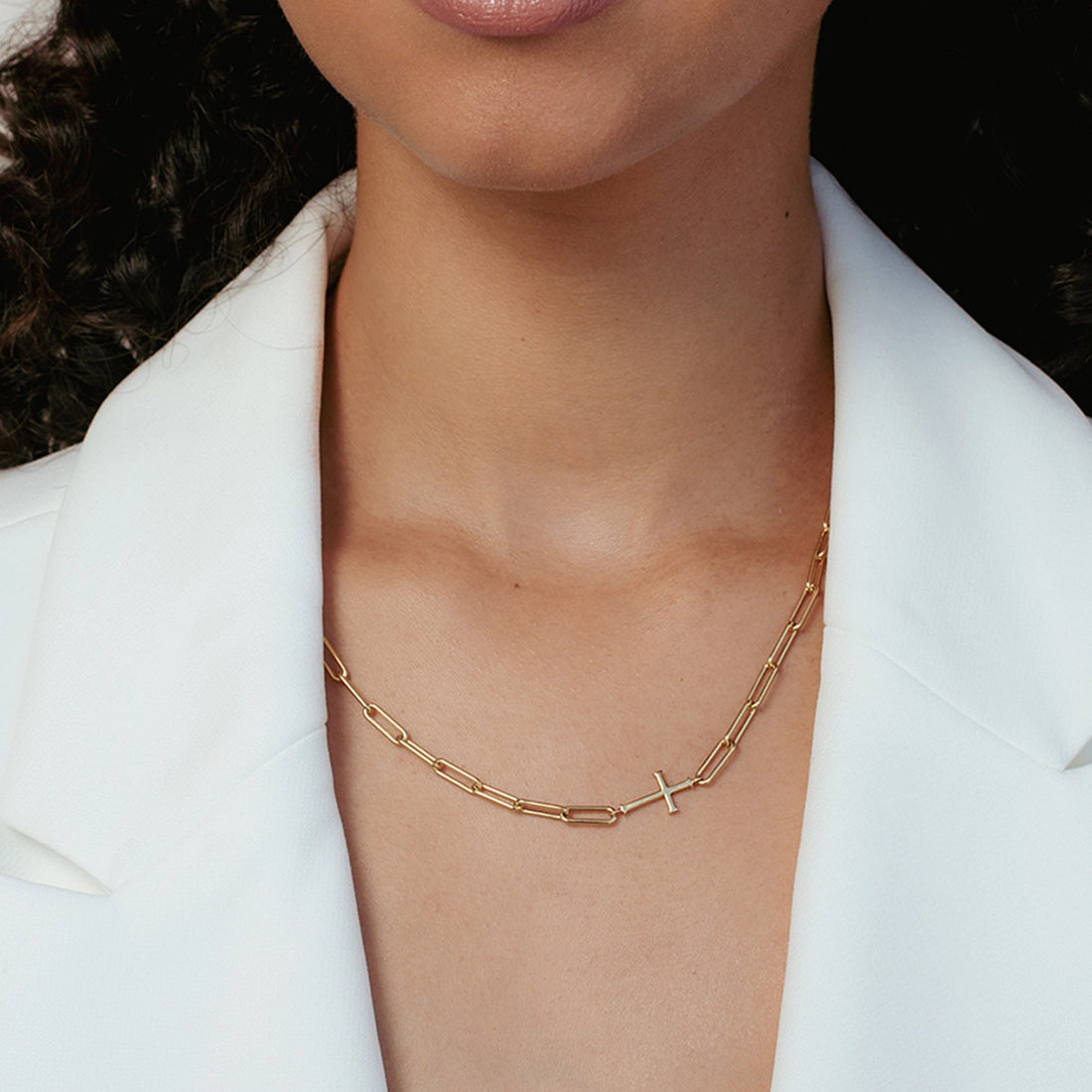Close up of christian woman wearing paperclip chain breaker cross station necklace in 18k gold vermeil from the calvary collection by Rizen Jewelry.