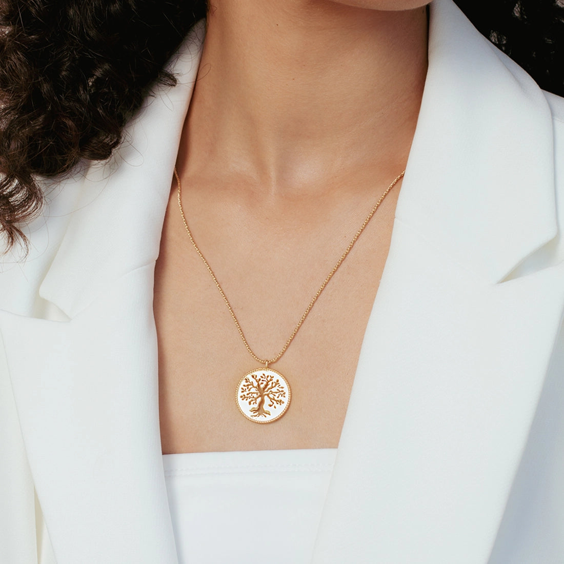 Close up of christian woman wearing the 18k gold vermeil Olive Tree Necklace from the Rooted Collection by Rizen Jewelry.