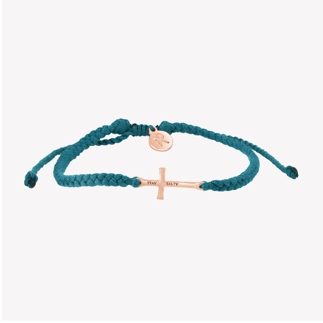 Christian rose gold  cross bracelet engraved "STAY SALTY" hand braided azure blue cotton cords by Rizen Jewelry Made 4 Ministries collection. 