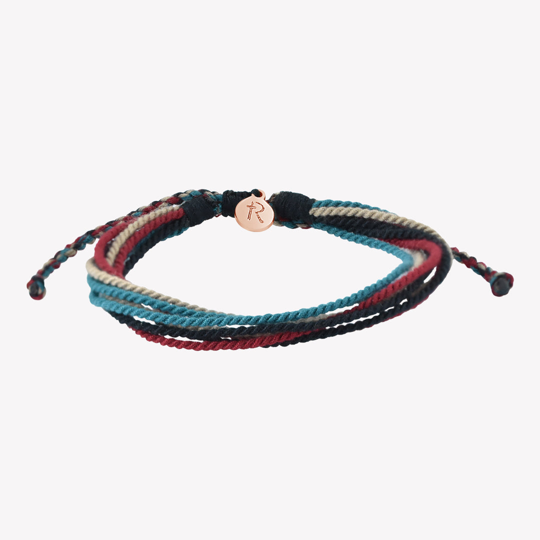 Rizen Jewelry Be Magnified Faithful multicord macrame bracelet. Cotton cords in black, garnet red, azure blue, and khaki with rose gold tag. Made 4 Ministries Collection. 