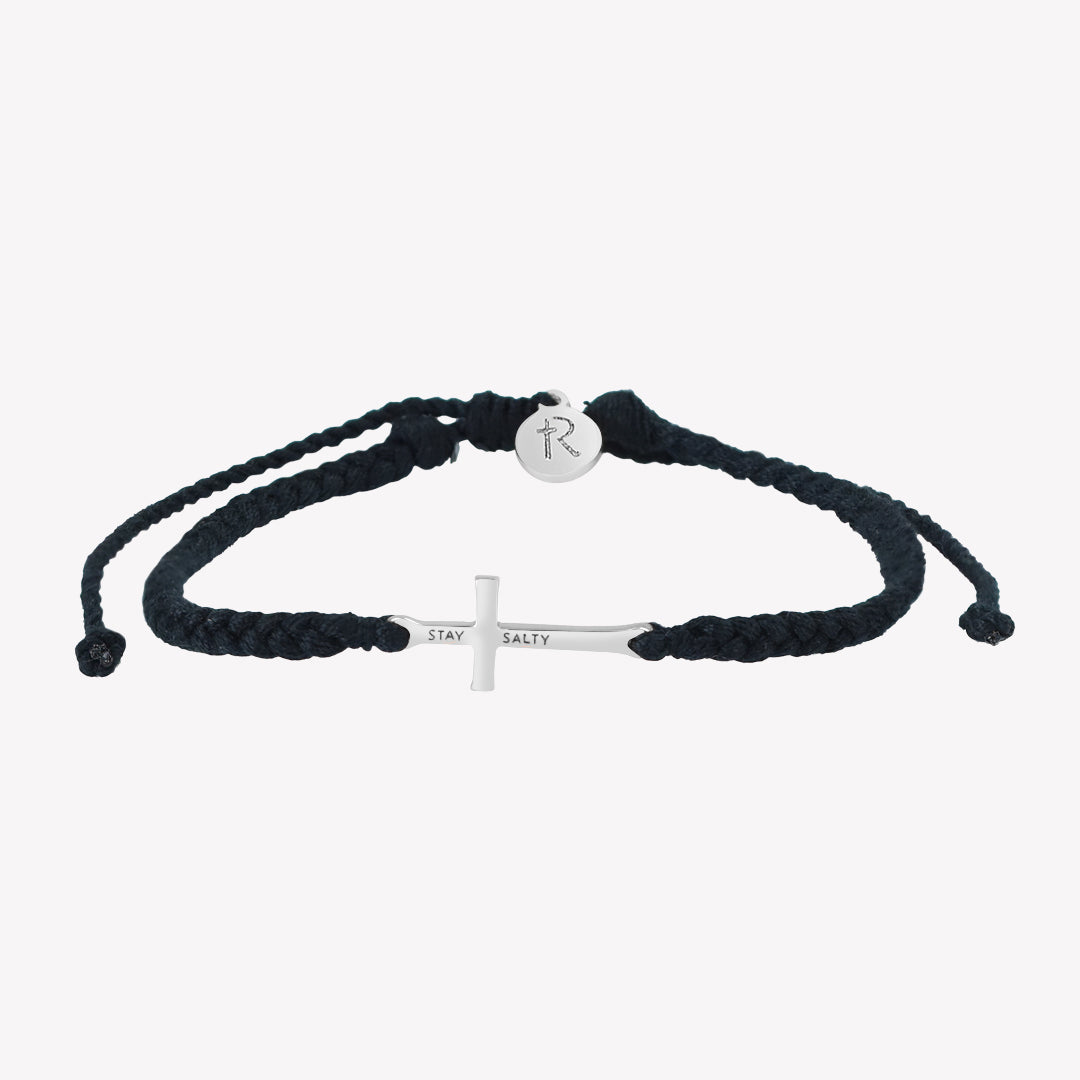 Christian silver cross bracelet engraved "STAY SALTY" hand braided black cotton cords with round Rizen Jewelry Made 4 Ministries tag.