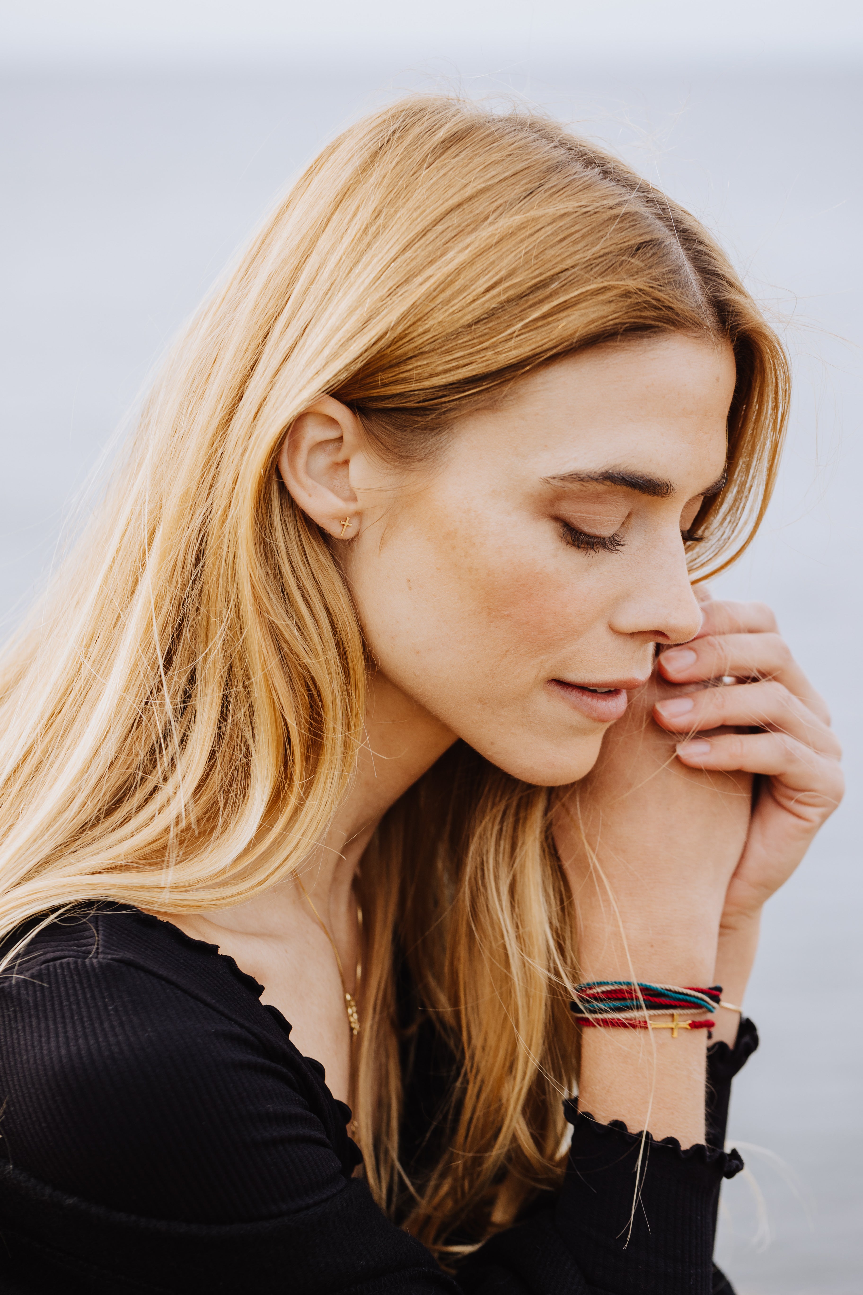 Rizen Jewelry Be Magnified Faithful multicord macrame bracelet. Christian designer mdel wearing Made 4 Ministries cross Bracelet layer and cross stud earring