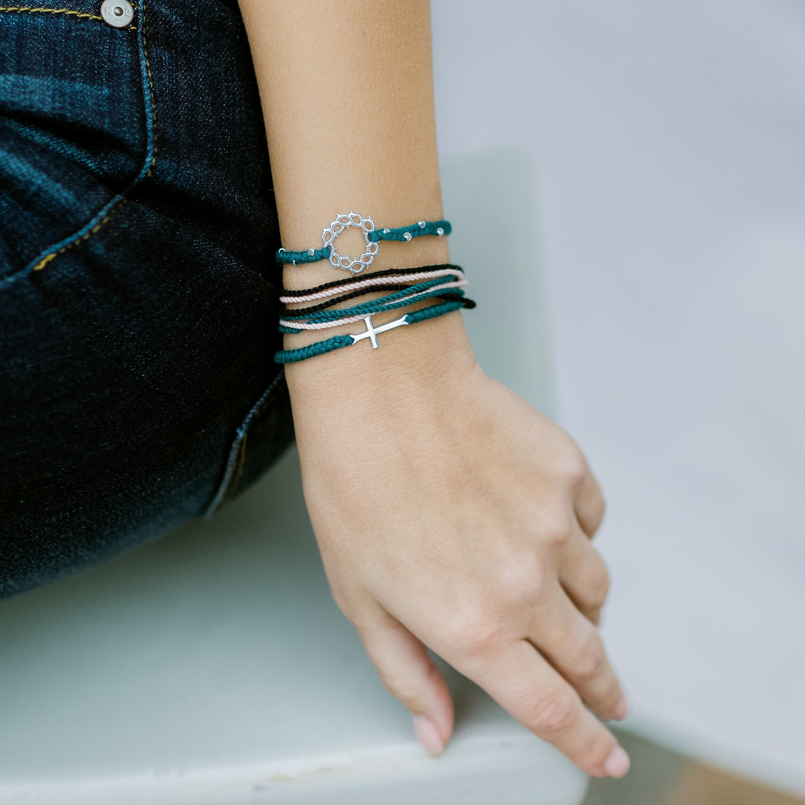 Christian model wearing the silver azure blue stay joyful bracelet set by Rizen jewelry Made 4 Ministries collection.