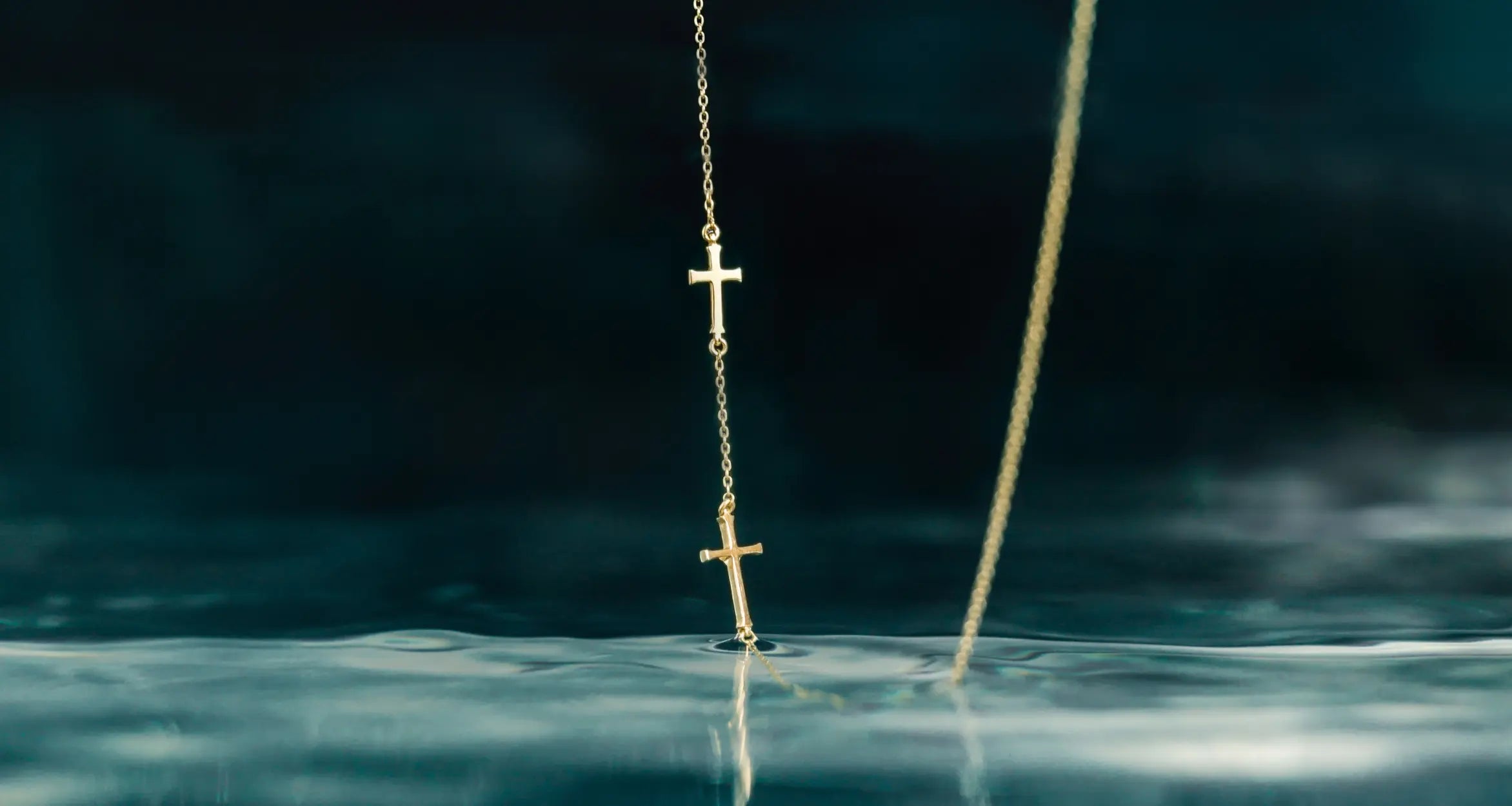 Rizen Jewelry Calvary Cross Necklace featuring three cross pendants cascading on a delicate cable chain.