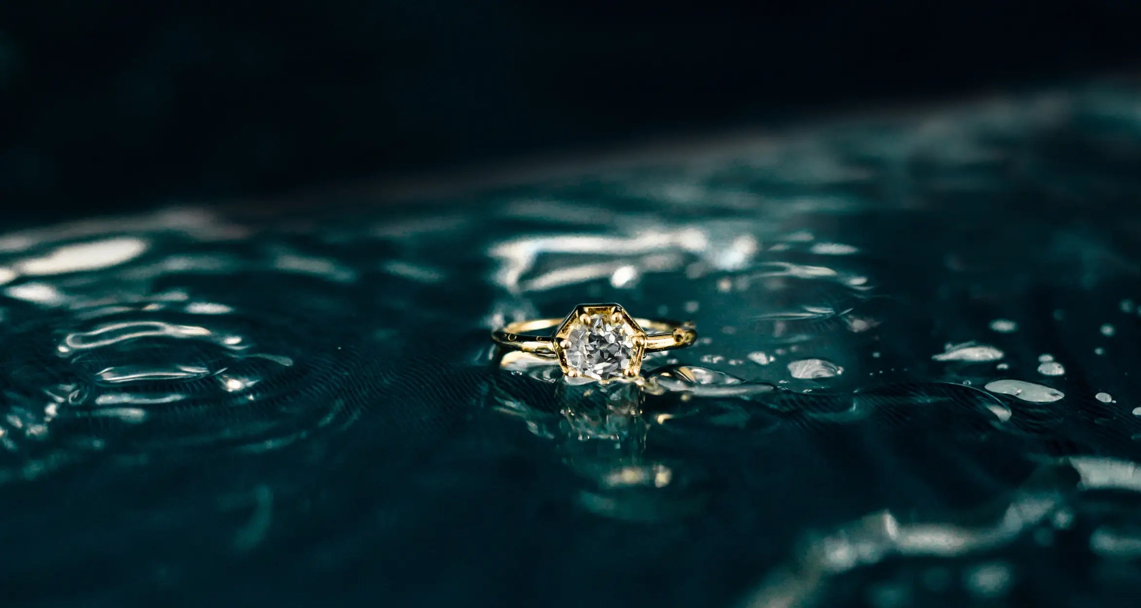 Rizen Jewelry Chispa Collection Ebenezer ring with white topaz in a heptagon seven prong setting