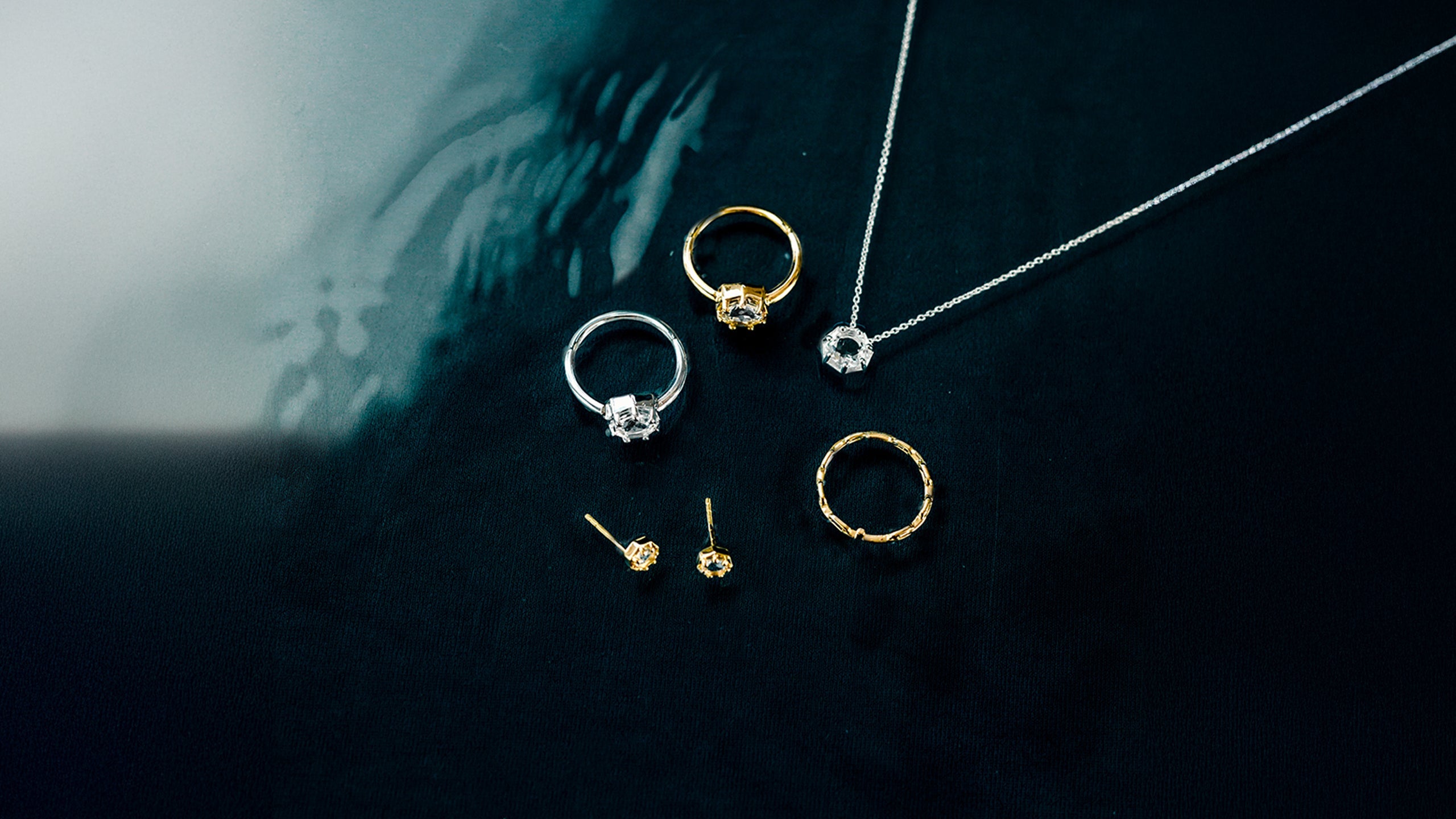 Christian model wearing faith inspired Rizen Jewelry designs.  Necklaces are silver crown of thorns and gold chispa de la dove, and mini cross stud earrings. 