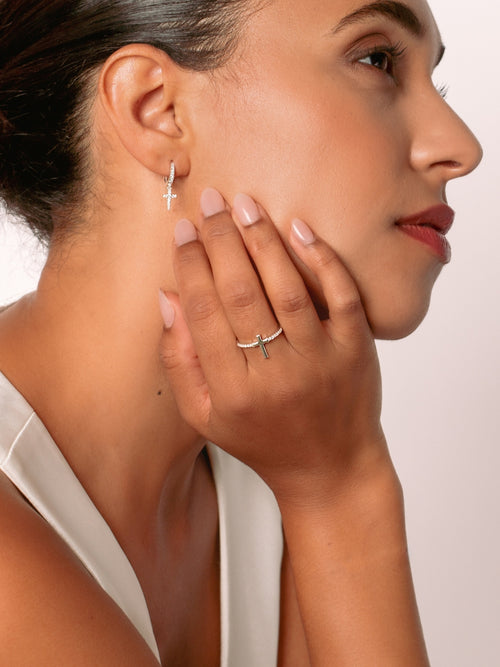 Women's Christian jewelry model is wearing the Luminous cross pave ring in sterling silver alongside earrings from the Calvary collection. A wonderful Christian Jewelry Gift by Rizen Jewelry.
