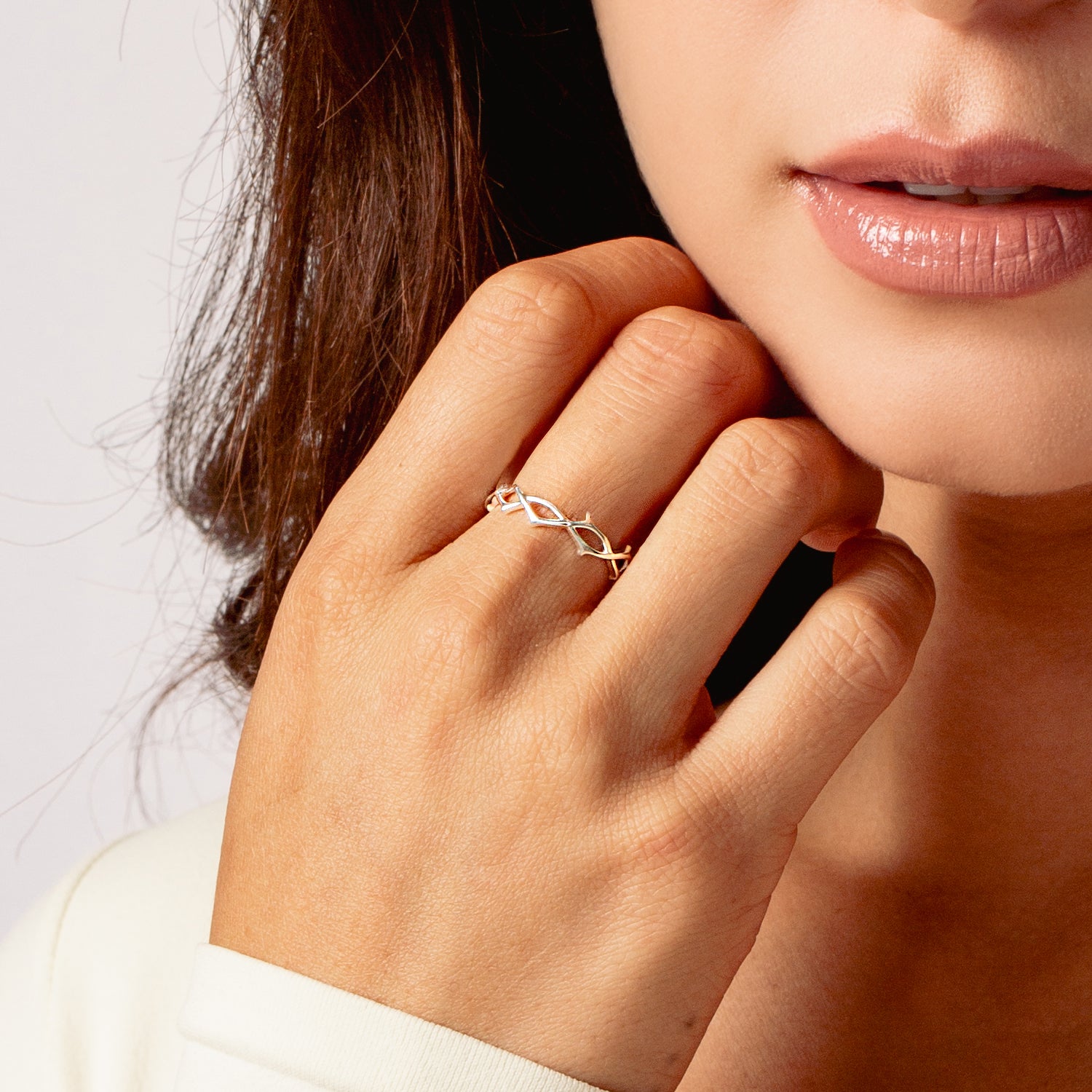 Crown of Thorns Band Ring in sterling silver worn by female christian jewelry model from the Insignia Collection by Rizen Jewelry.