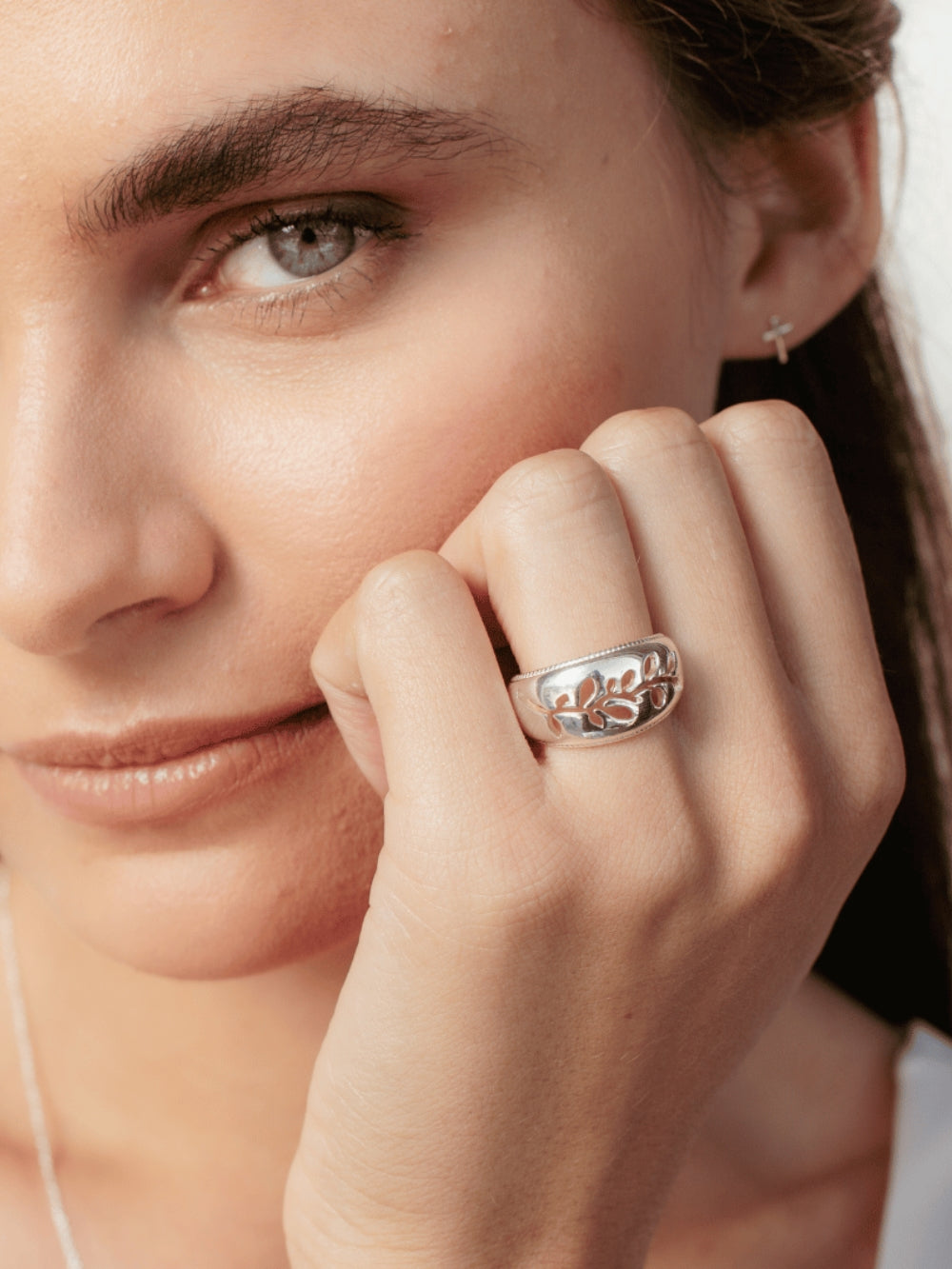 Women's Christian jewelry model is wearing the Olive branch ring in sterling silver from the Rooted collection.  Inspirational gift for any occasion by Rizen Jewelry.