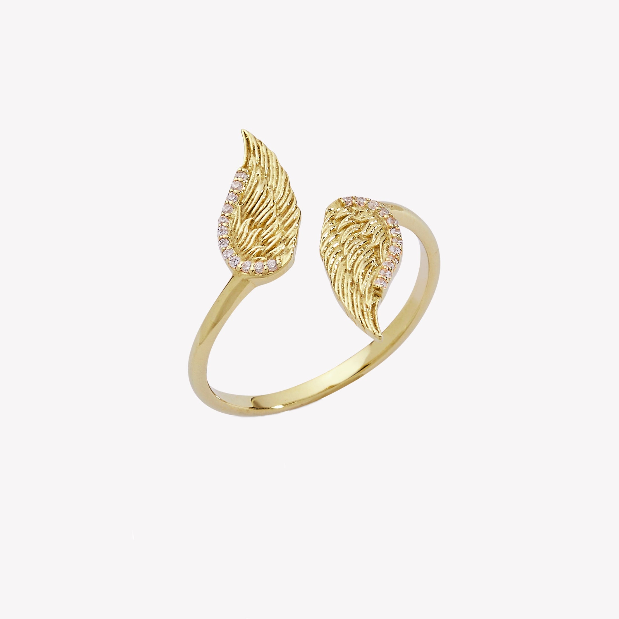 Captivating double angel wing motif ring, elegantly outlined with sparkling cubic zirconia accents. Crafted in 18k gold, generously plated over sterling silver.