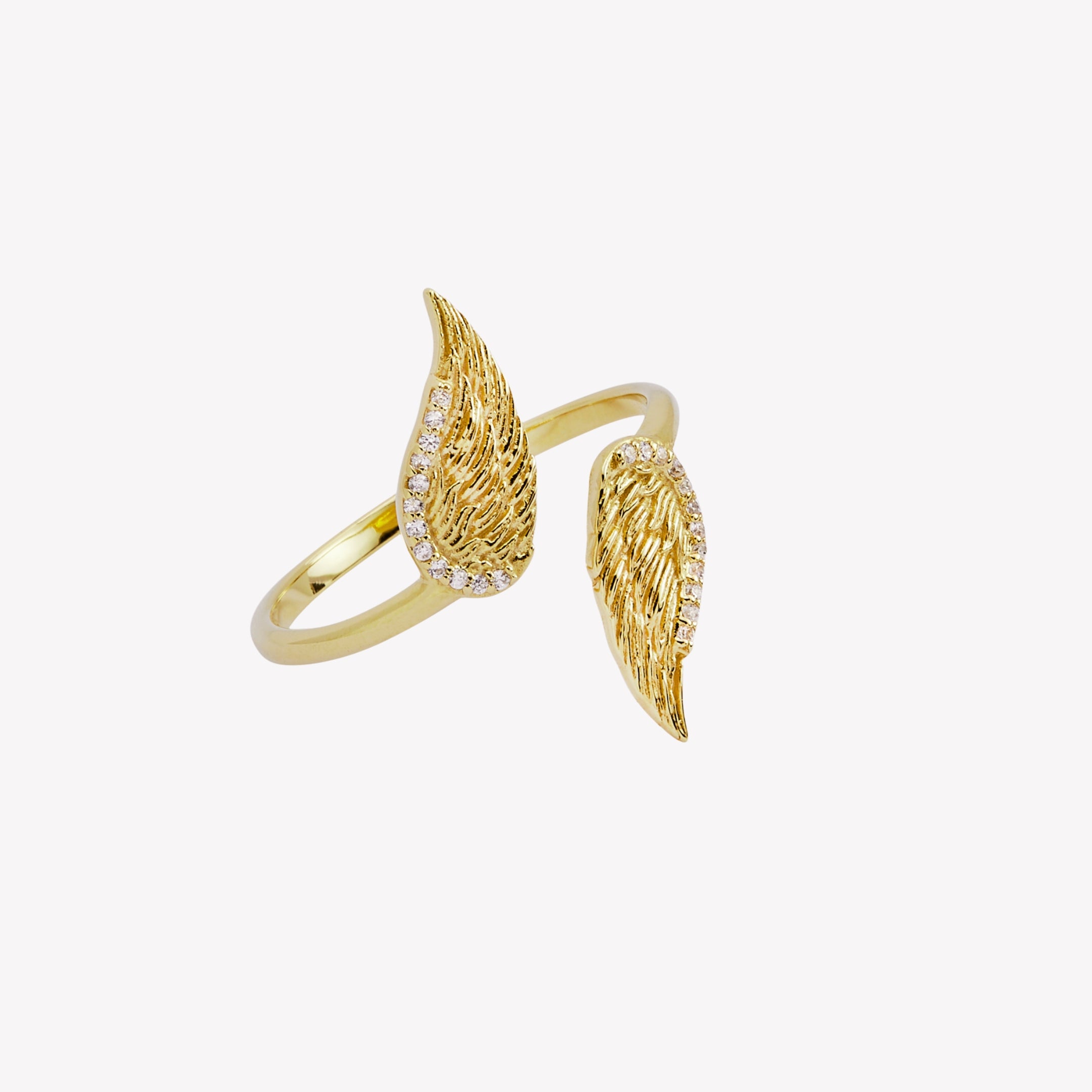 Captivating double angel wing motif ring, elegantly outlined with sparkling cubic zirconia accents. Crafted in 18k gold, generously plated over sterling silver.