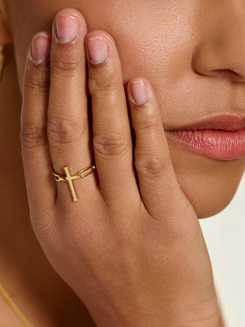 Women's Christian jewelry model wearing the large Chain Breaker Cross Statement Ring by Rizen Jewelry. 