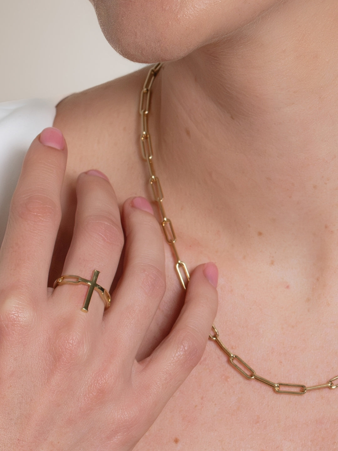 Women's Christian jewelry model wearing the large Chain Breaker Cross Statement Ring by Rizen Jewelry. 