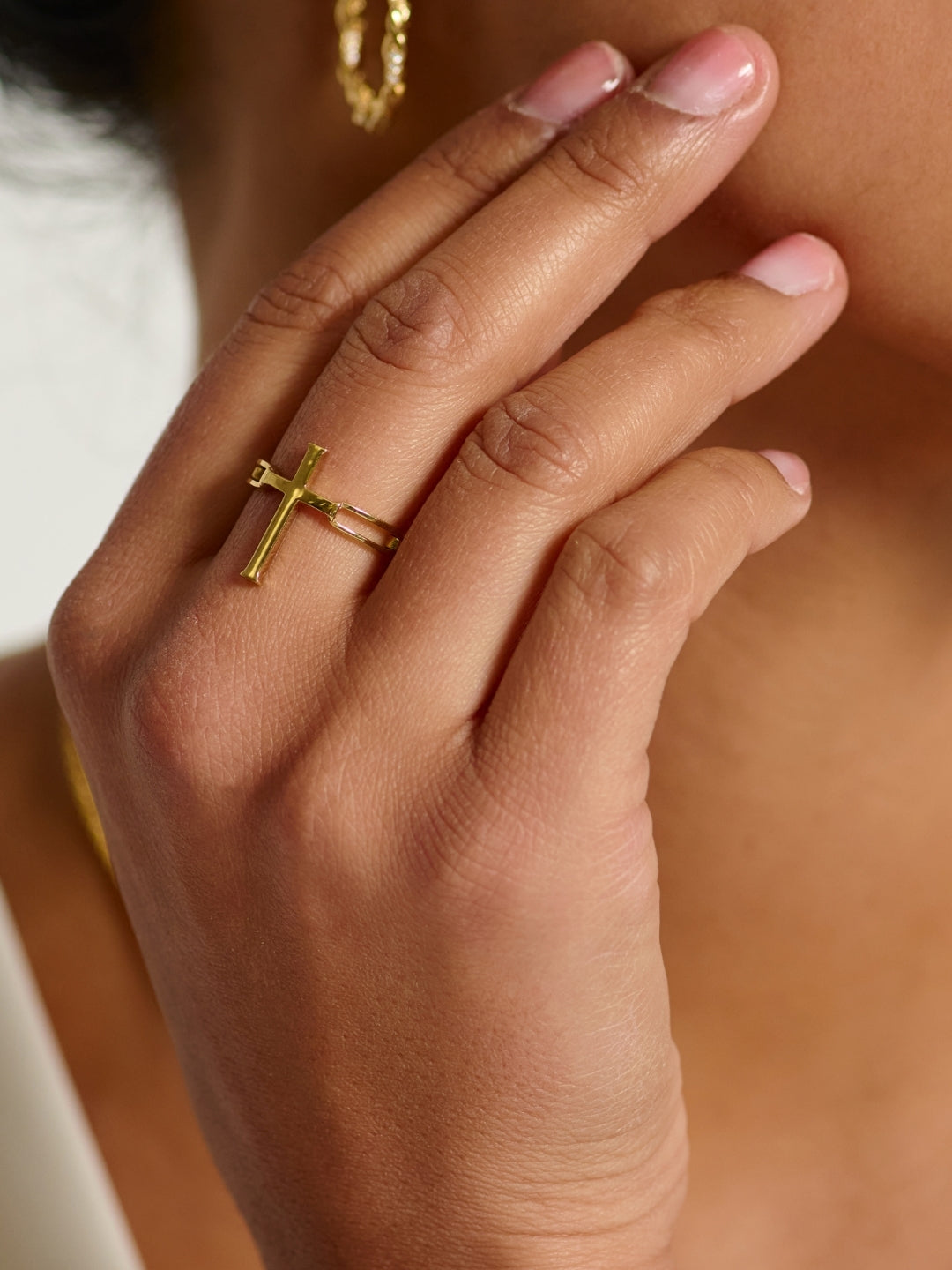Women's Christian jewelry model wearing the large Chain Breaker Cross Statement Ring by Rizen Jewelry. 