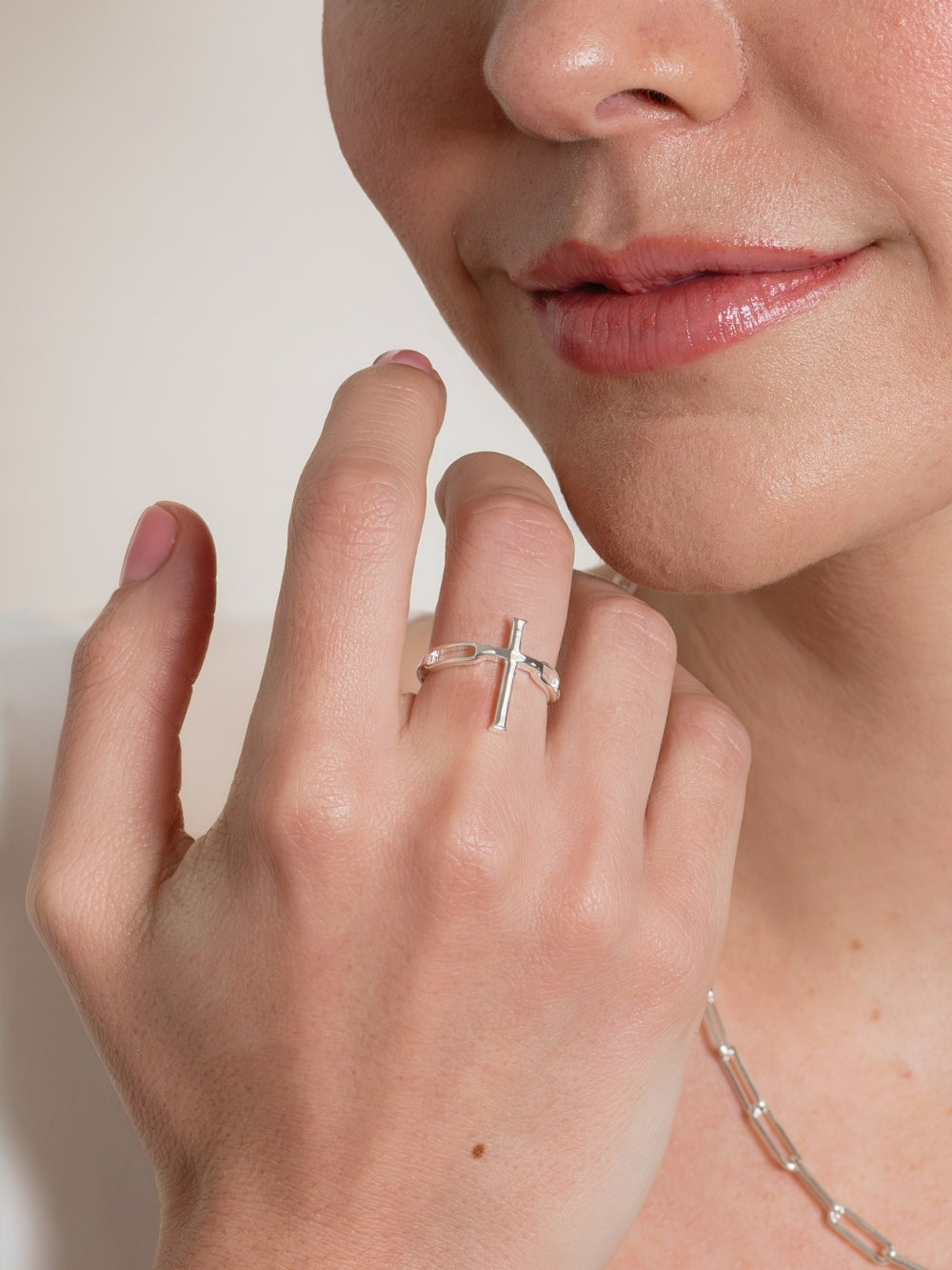Woman's Christian jewelry model wearing the Silver Chain Breaker Cross Statement Ring by Rizen Jewelry. 
