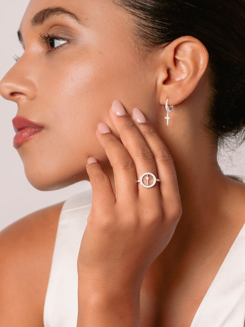 Women's Christian jewelry model is wearing the Adoring star compass ring in sterling silver from the Insignia collection and earrings from the Calvary collection.  Inspirational gift for any occasion by Rizen Jewelry.