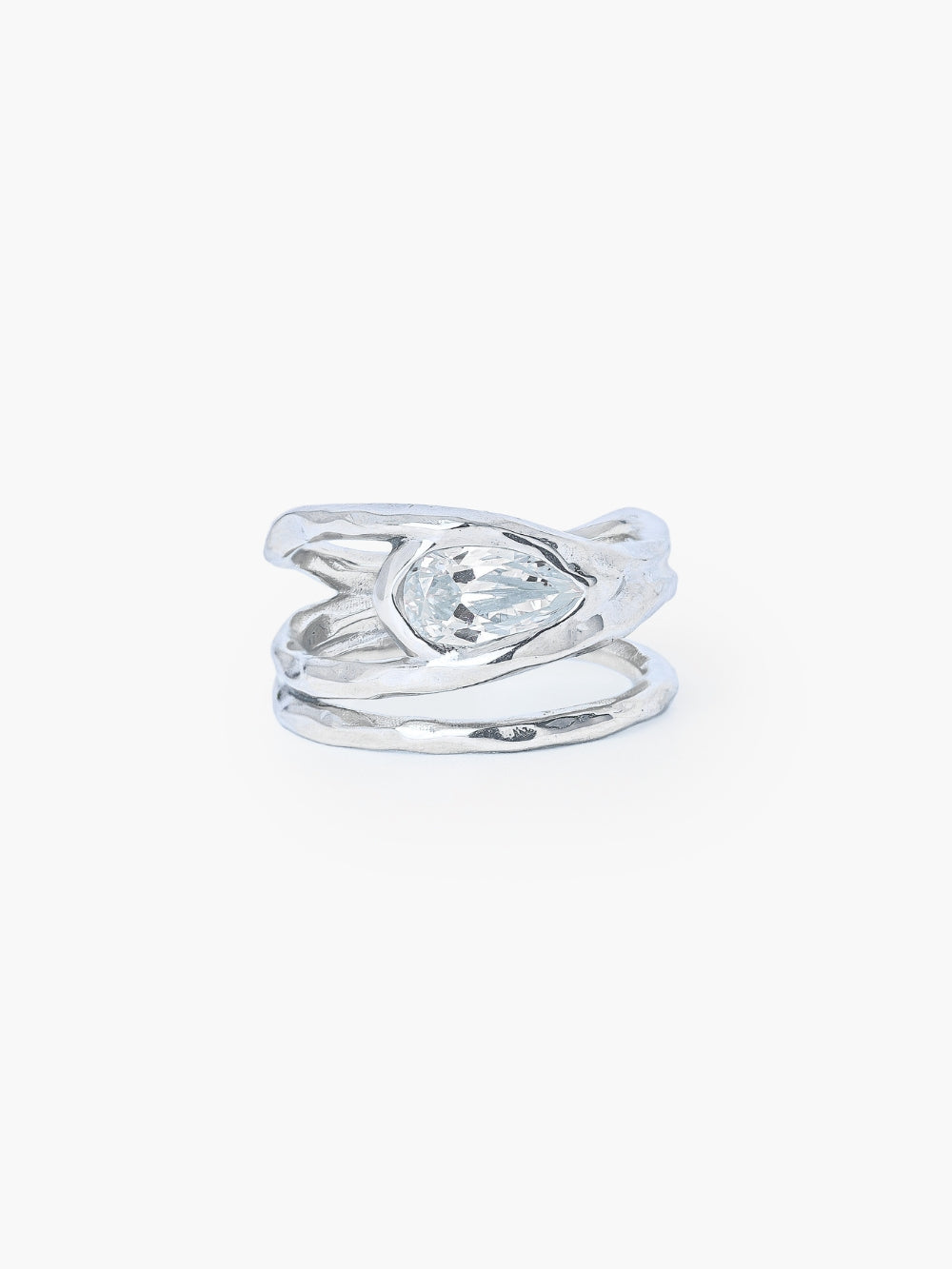 A tear-shaped simulated diamond ring framed within a hammer-textured setting, crafted with soft, reflective fluid curves. The Rizen Jewelry Solace Teardrop Statemnet Ring is crafted in sterling silver.