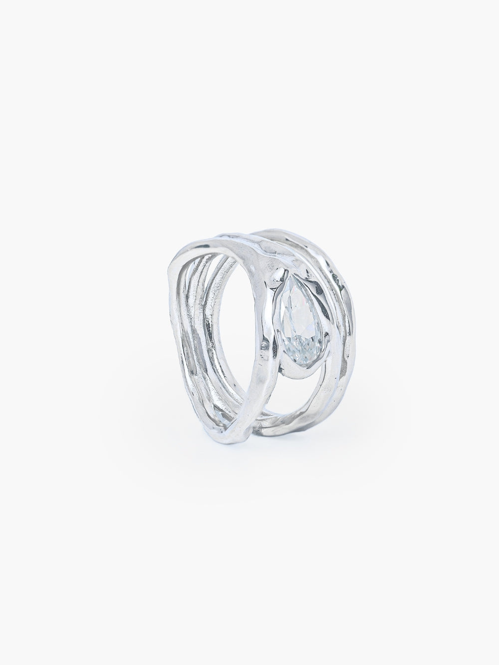 A tear-shaped simulated diamond ring framed within a hammer-textured setting, crafted with soft, reflective fluid curves. The Rizen Jewelry Solace Teardrop Statemnet Ring is crafted in sterling silver.